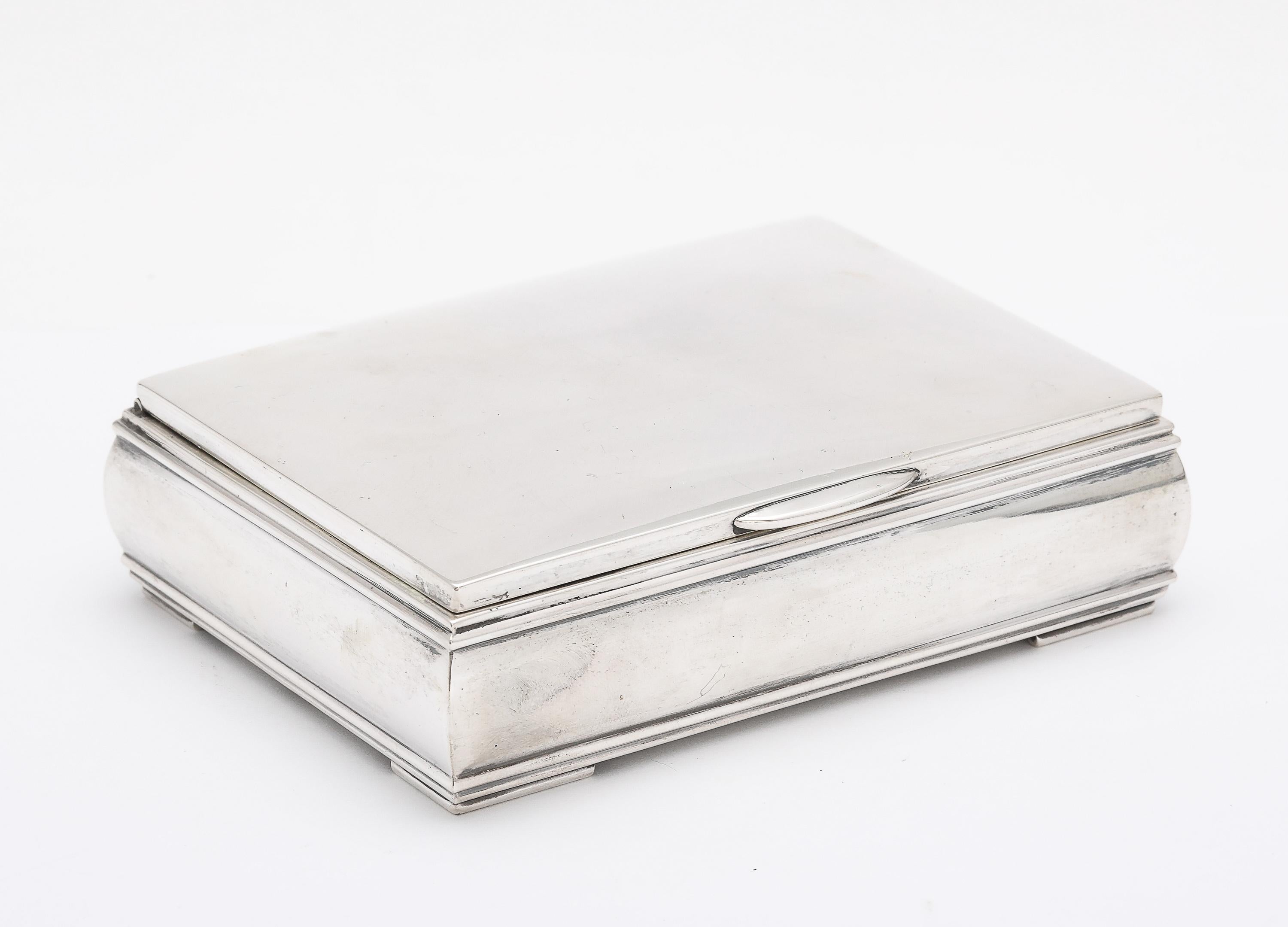 Unusual, Mid-Century Modern, sterling silver table box, with hinged lid, American, Ca. 1940's-1950's. Measures over 4 1/2 inches wide x almost 3 1/2 inches deep (at deepest point) x 1 1/4 inches high. The sides of the box are rounded to create a
