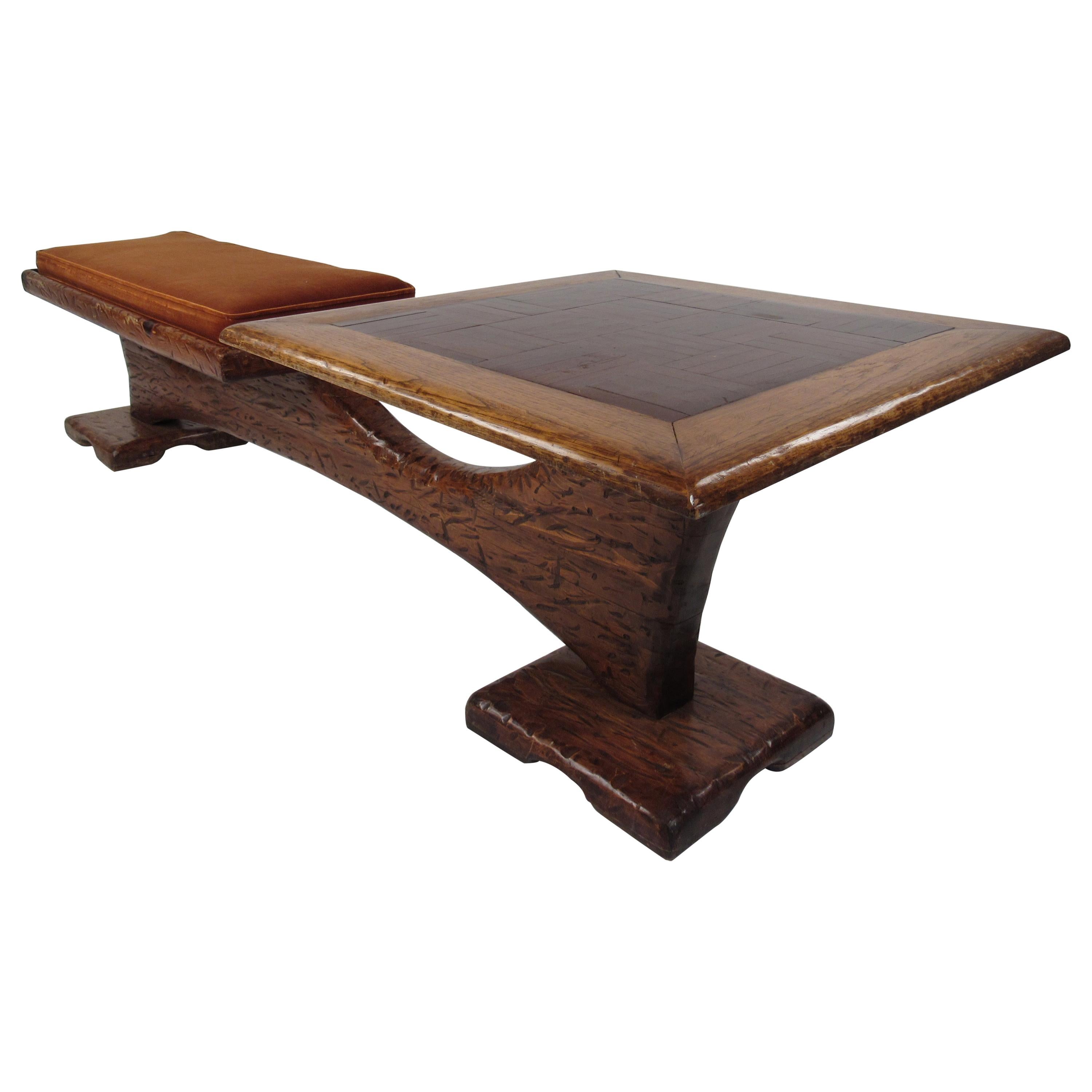 This amazing vintage modern piece combines seating and a table all in one. A one of a kind two-tone Witco style piece that is made with carved wood. A thick cushion rests on a sturdy pedestal style base that connects each side with a sculpted