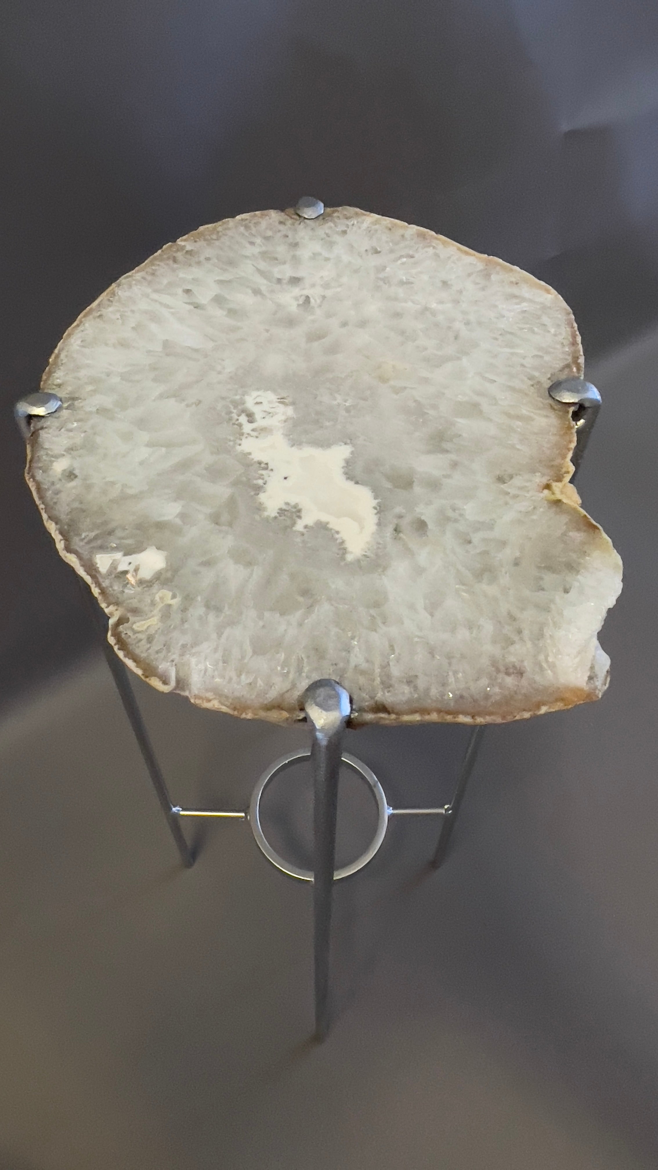 Our gorgeous geode drink tables are a perfect addition to any sitting room, particularly in an area where the light catches them just right. Handcrafted with one of a kind quartzite slabs and silver gilt metal. This geode slab is predominately