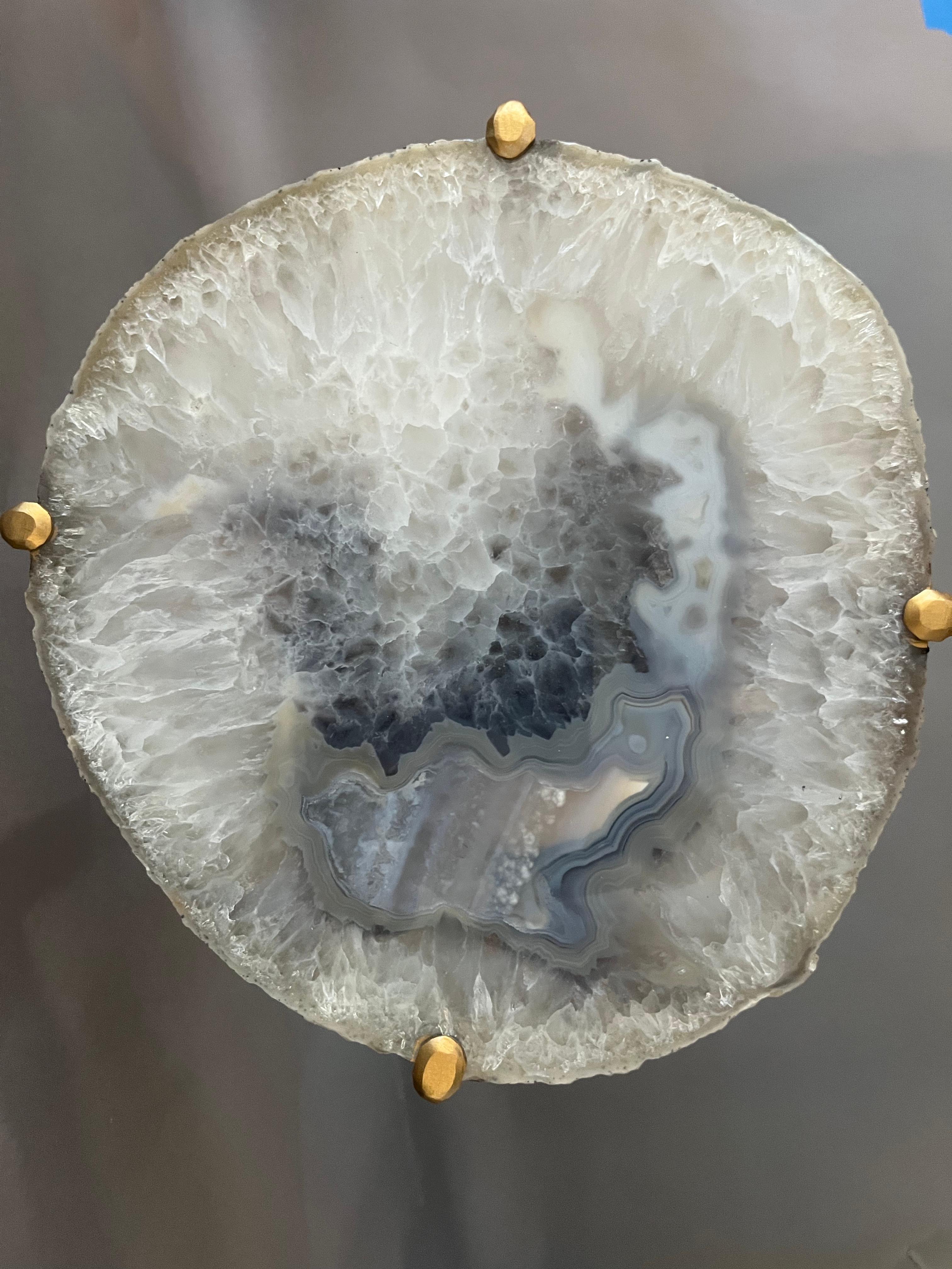 Our Geode Tables are crafted using one of a kind quartzite slabs, polished and set into a modern steel base. The depth of tone within the geode, when near a light source is captivating.  Handcrafted with one of a kind quartzite slabs and gold gilt