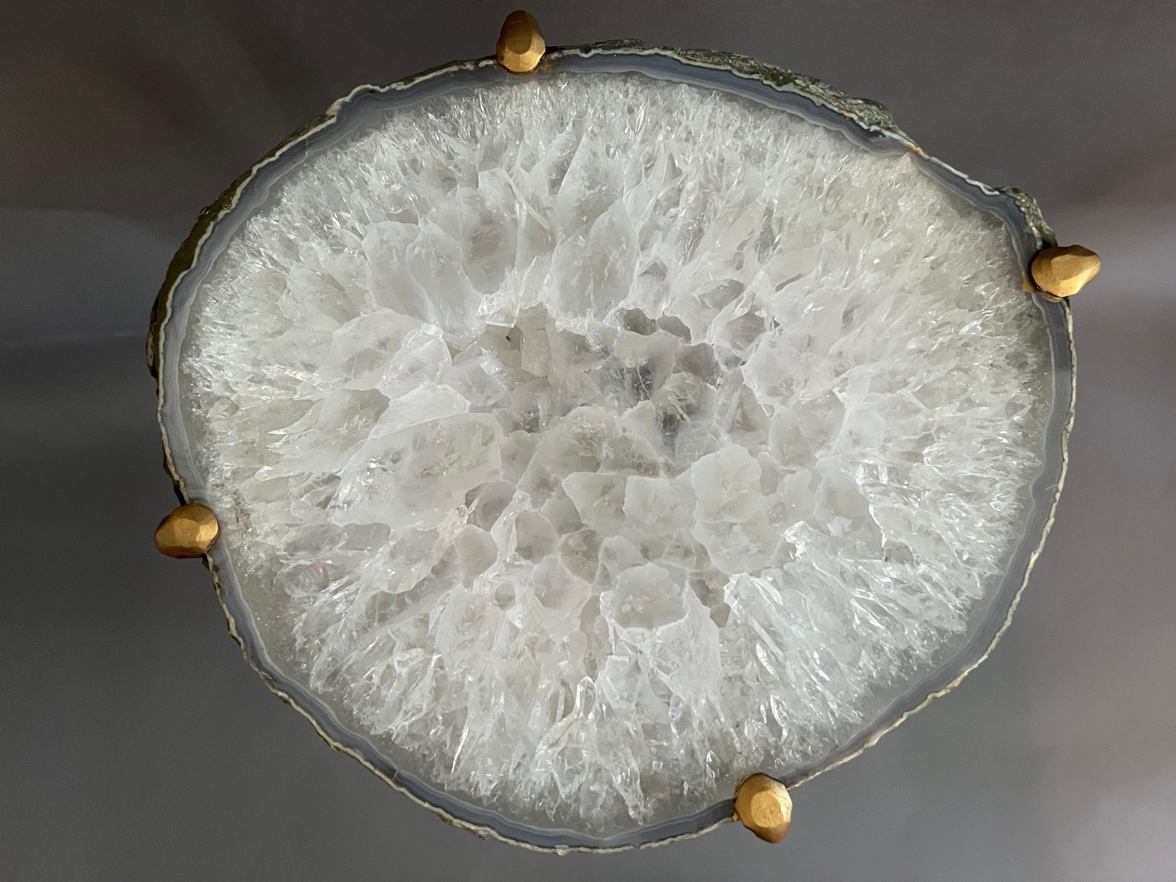 Our gorgeous geode drink tables are a perfect addition to any sitting room, particularly in an area where the light catches them just right. Handcrafted with one of a kind quartzite slabs and gold gilt metal, this table is available as pictured or