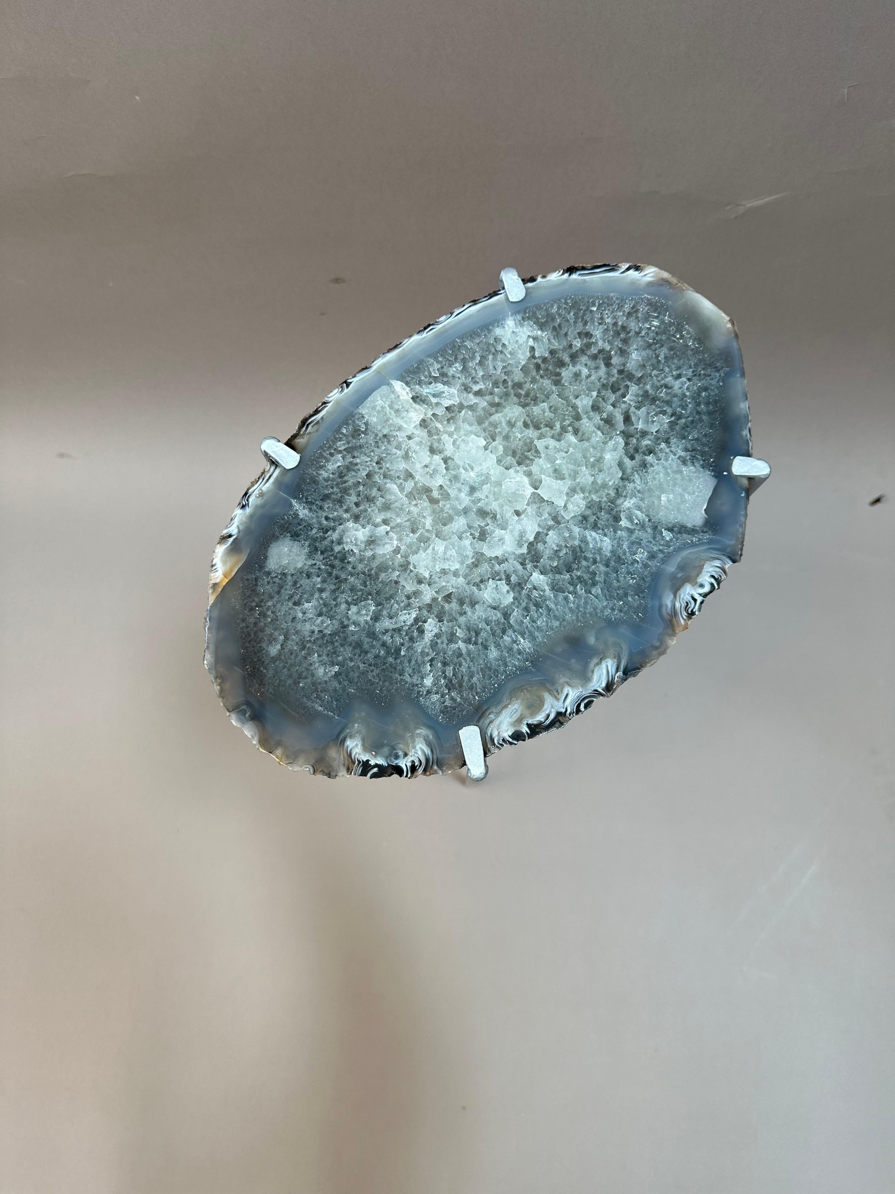 Unusual Modern Handcrafted Geode Drinks Table. Large quartzite oval top with silver gilt steel base. Unusually blueish green crystal with a light blue green center. 