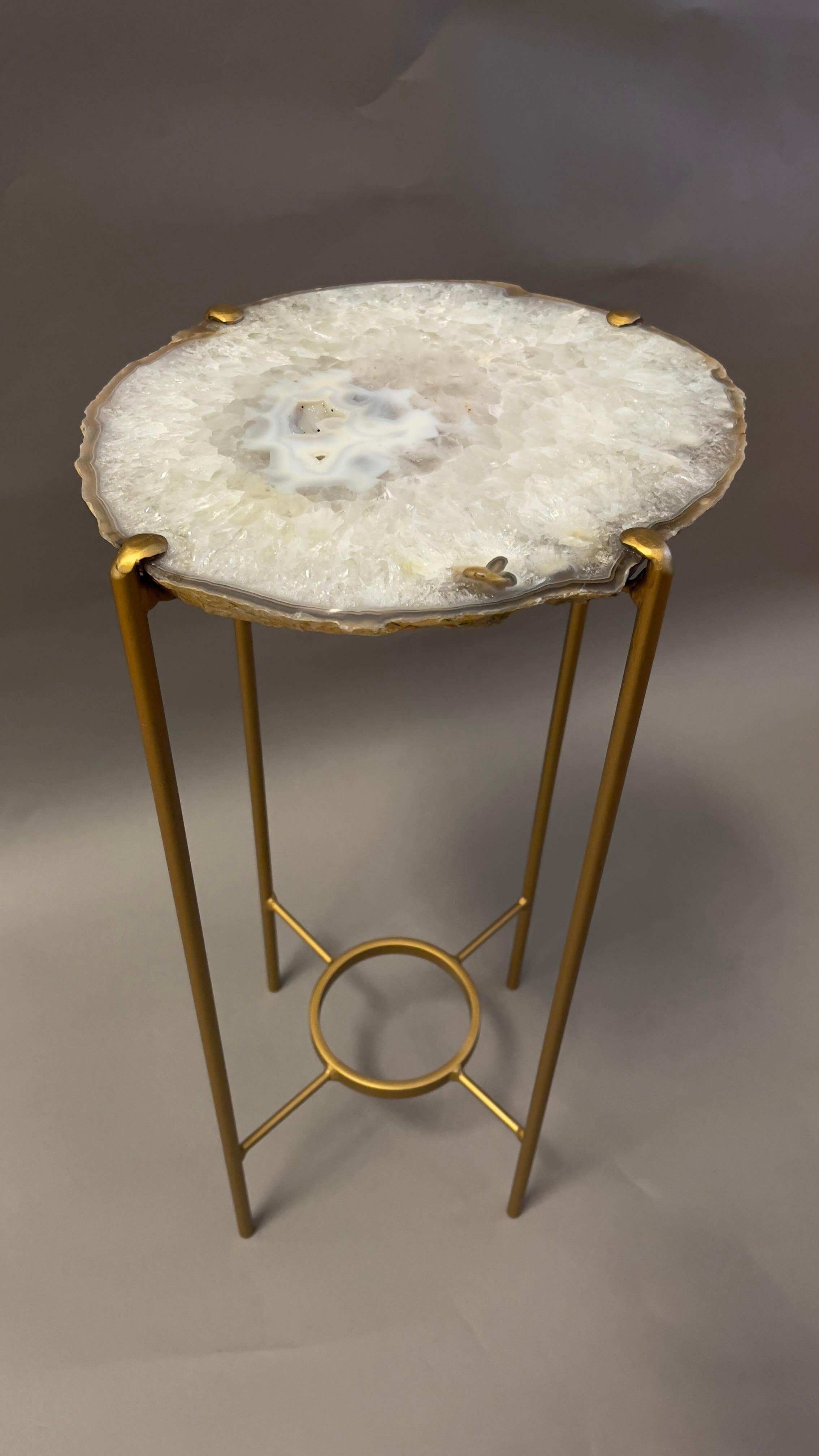 Our gorgeous geode tables are a perfect addition to any room, particularly when the light catches them just right. Each Agate surface unique in color, points of interest and shape.

Handcrafted with polished quartzite slabs atop a gilt metal base.