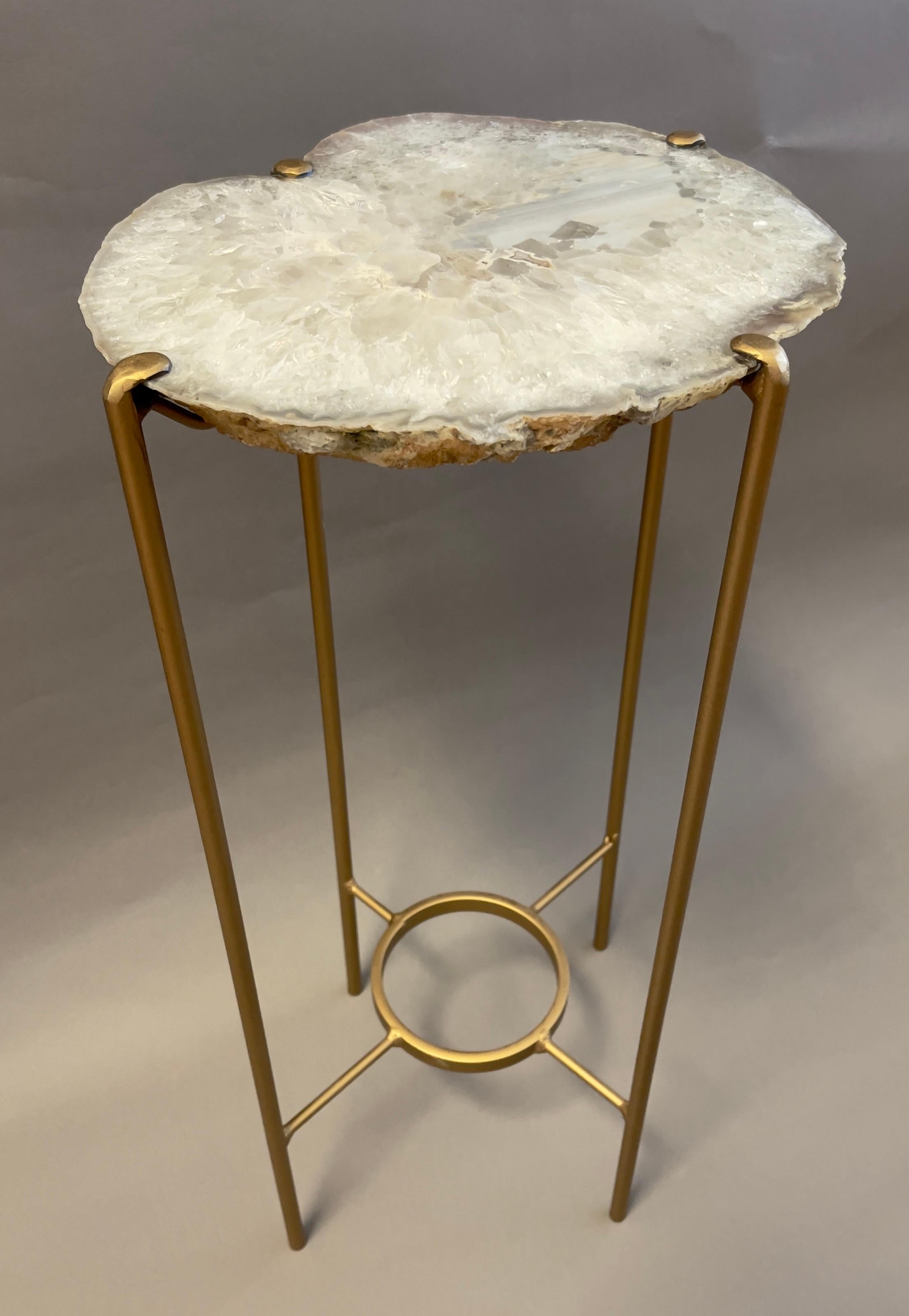 Our gorgeous geode drink tables are a perfect addition to any room, but particularly when light catches them just right. Handcrafted with one of a kind quartzite slabs and a gilt steel base.

Crystalline surface with subtle gray and white