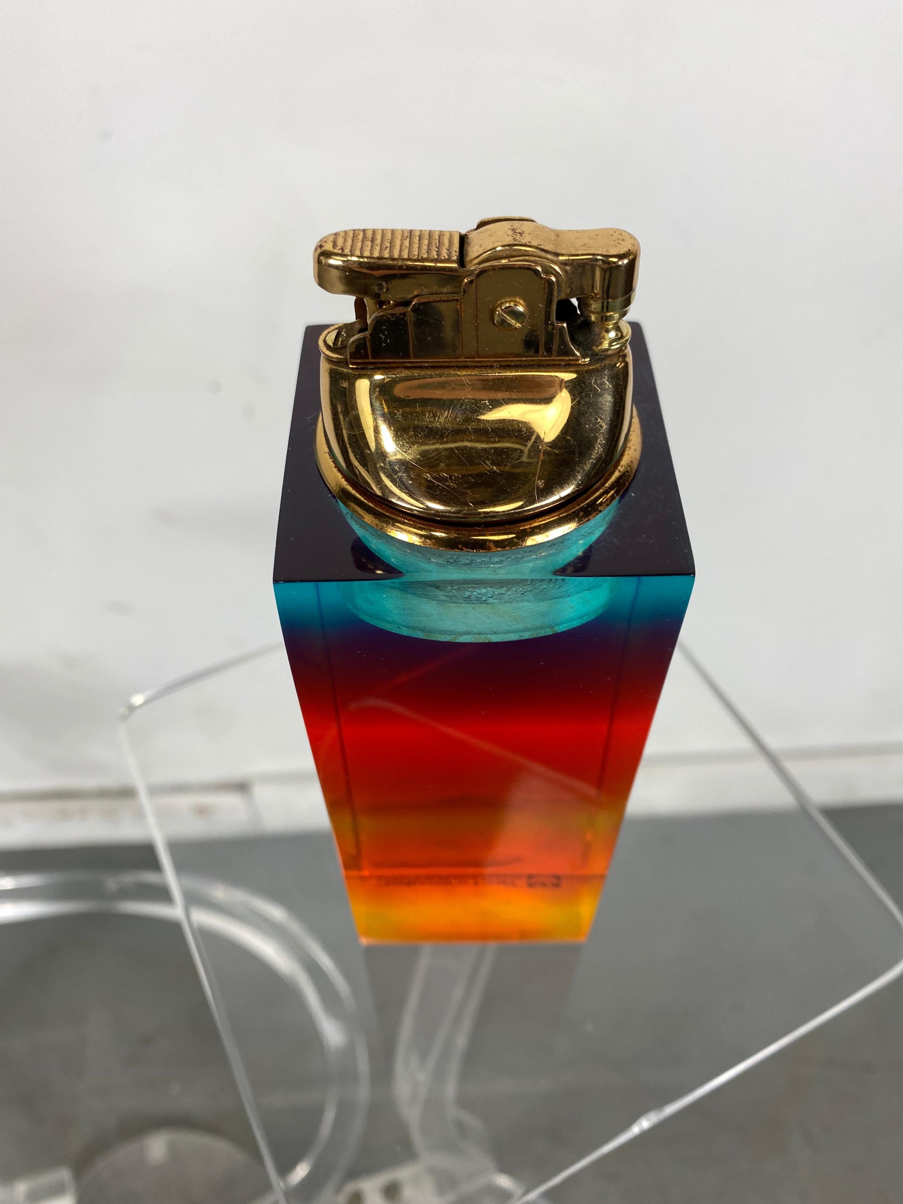 Unusual modernist multi-color acrylic / Lucite cigarette lighter, advertising Technicolor Corporation. Appears to be new/old stock, never used. Possible award or employee give away.