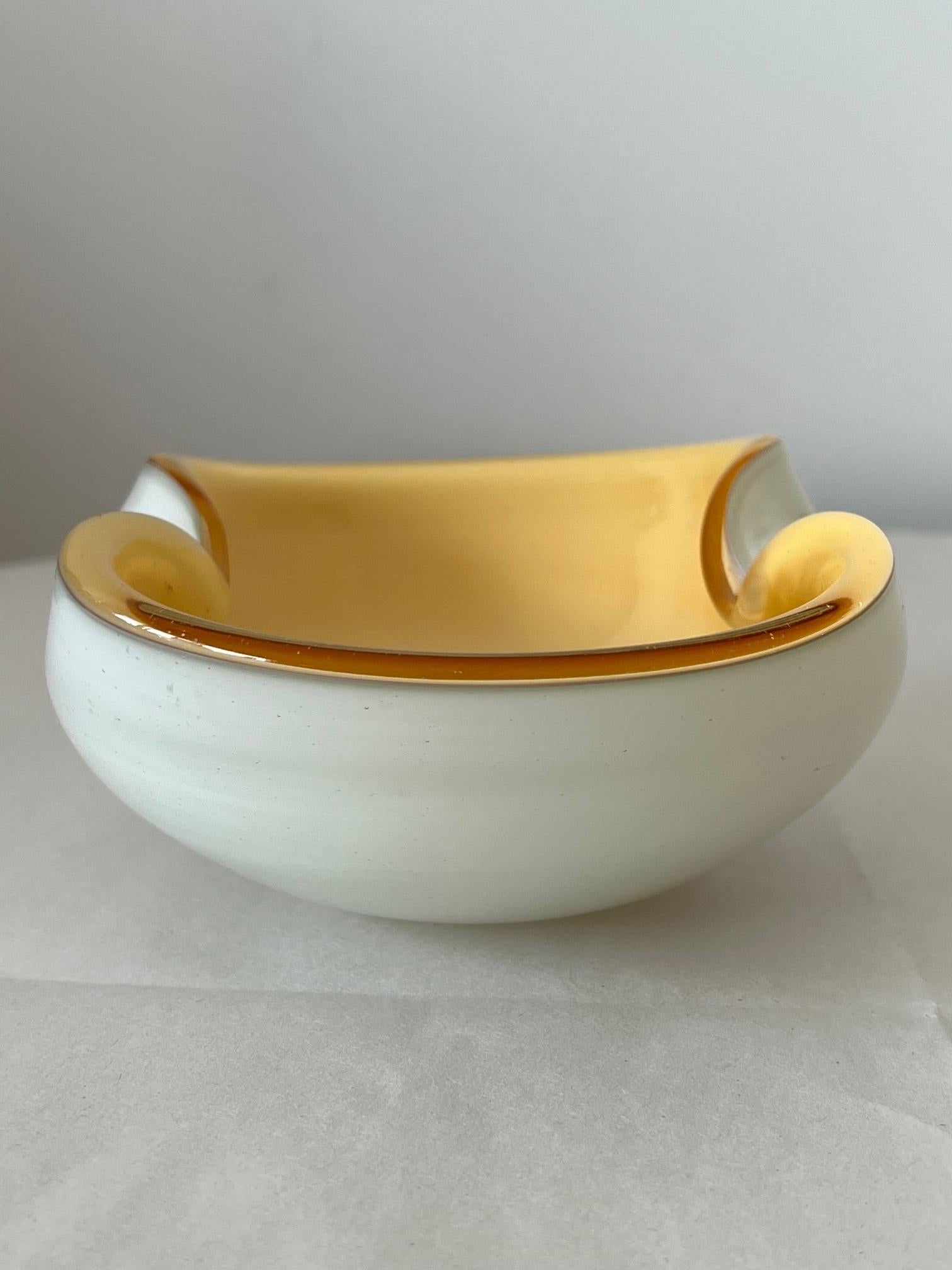 A charming glass bowl/ashtray with clear/cased glass and white/yellow tones. Unusual shape-Murano Italy made ca' 1950's.