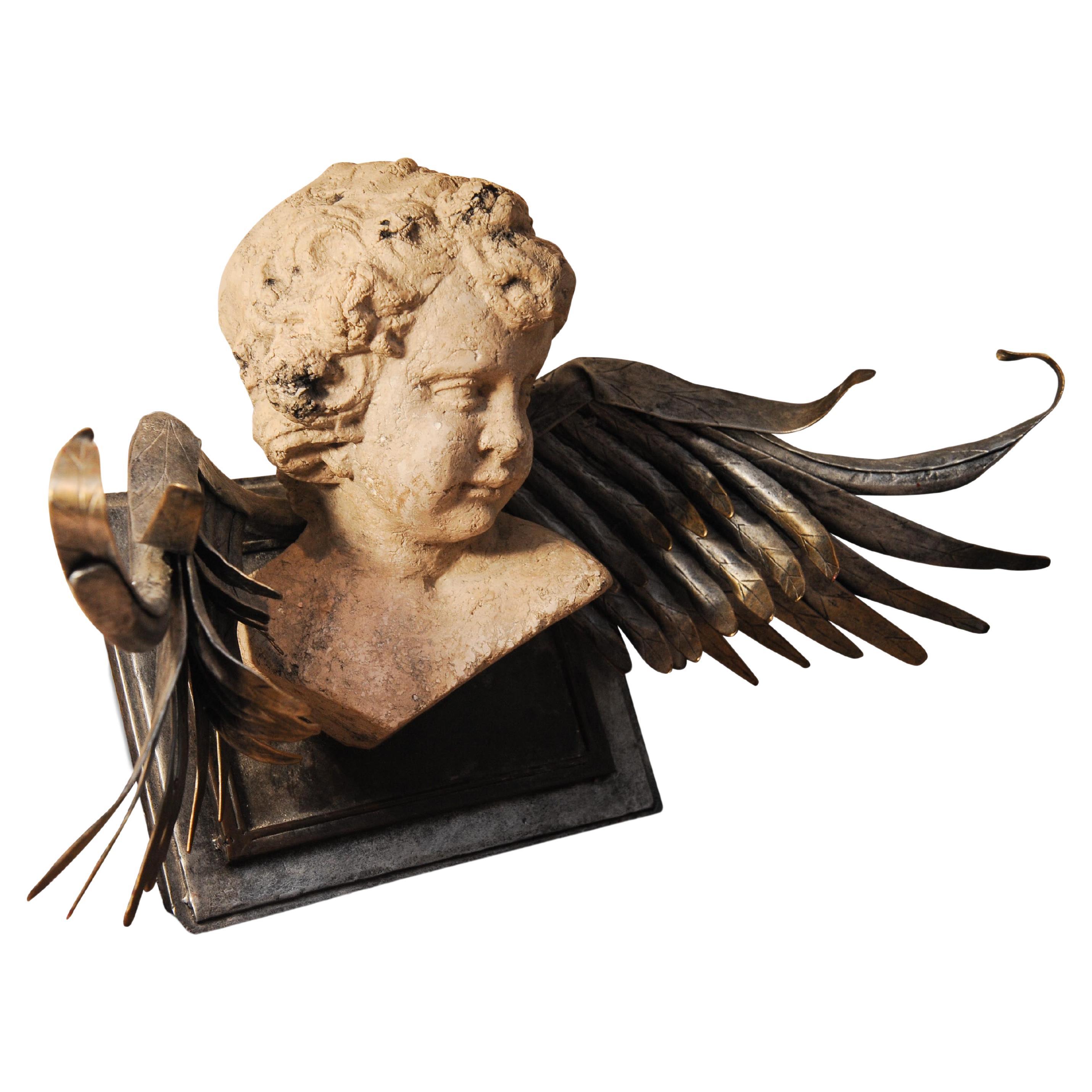 Unusual Decorative neoclassic Revival Putti/Cherub Stone Cast Sculpture With Metallic Wings, Wall Mountable.

Classicism is a specific genre of philosophy, expressing itself in literature, architecture, art, and music, which has Ancient Greek and
