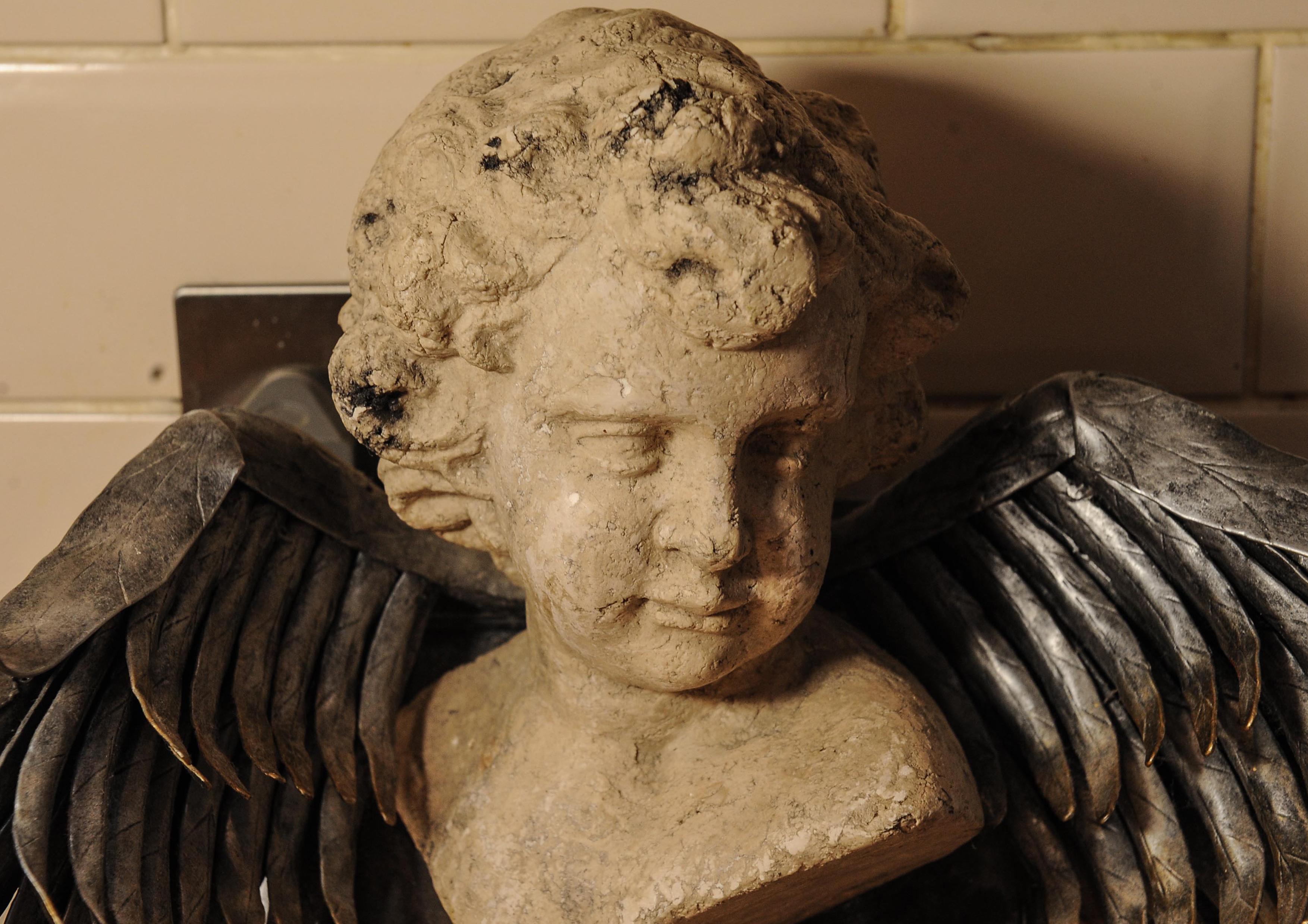 Carved Unusual Neoclassical Style Wall Mounted Stone Cherub / Angel with Silver Wings For Sale