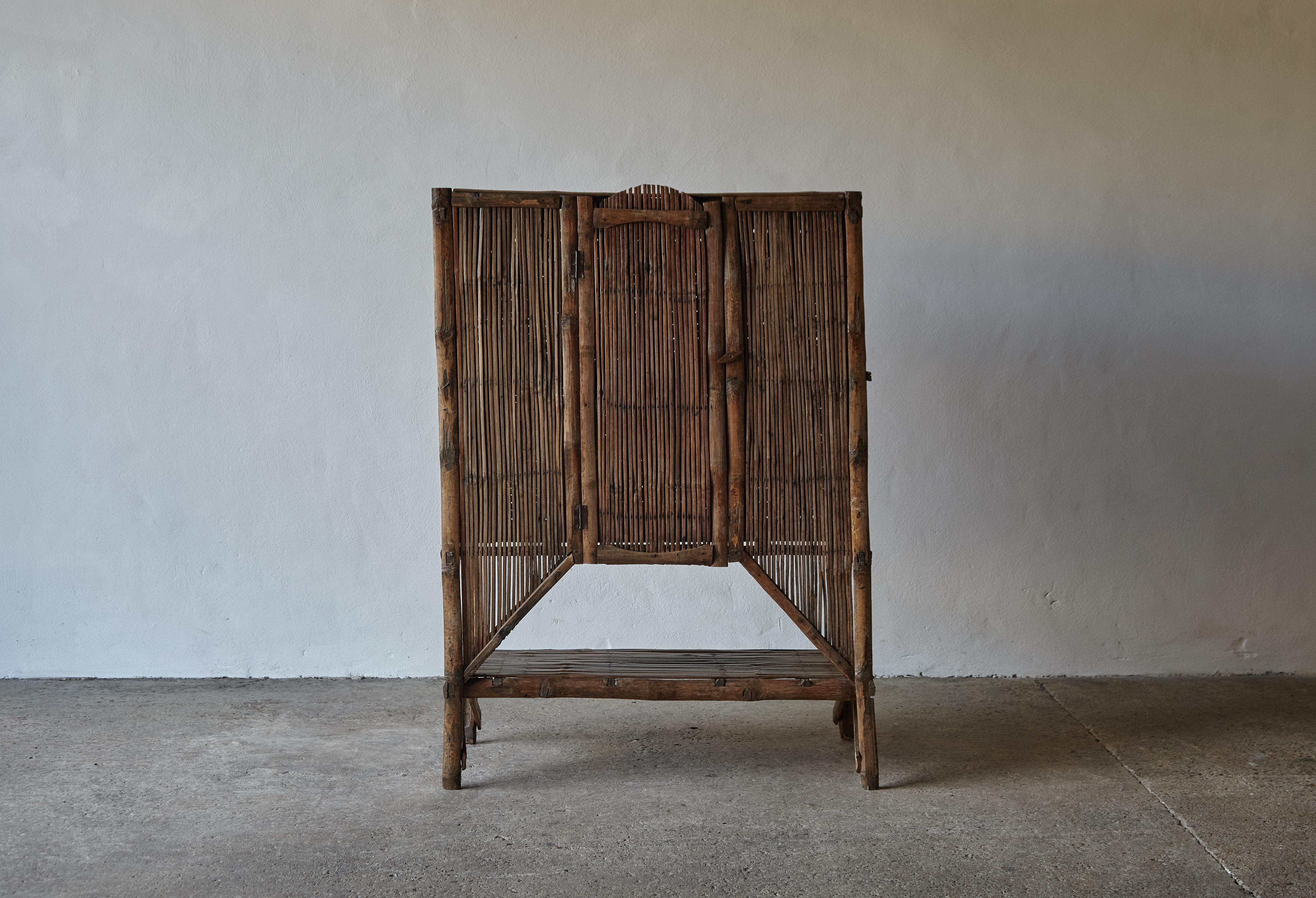 An unusual and striking bamboo cabinet in original condition with a great tone and patina. Quite delicate in construction so probably not suitable for heavy use. Wear consistent with age and use.


