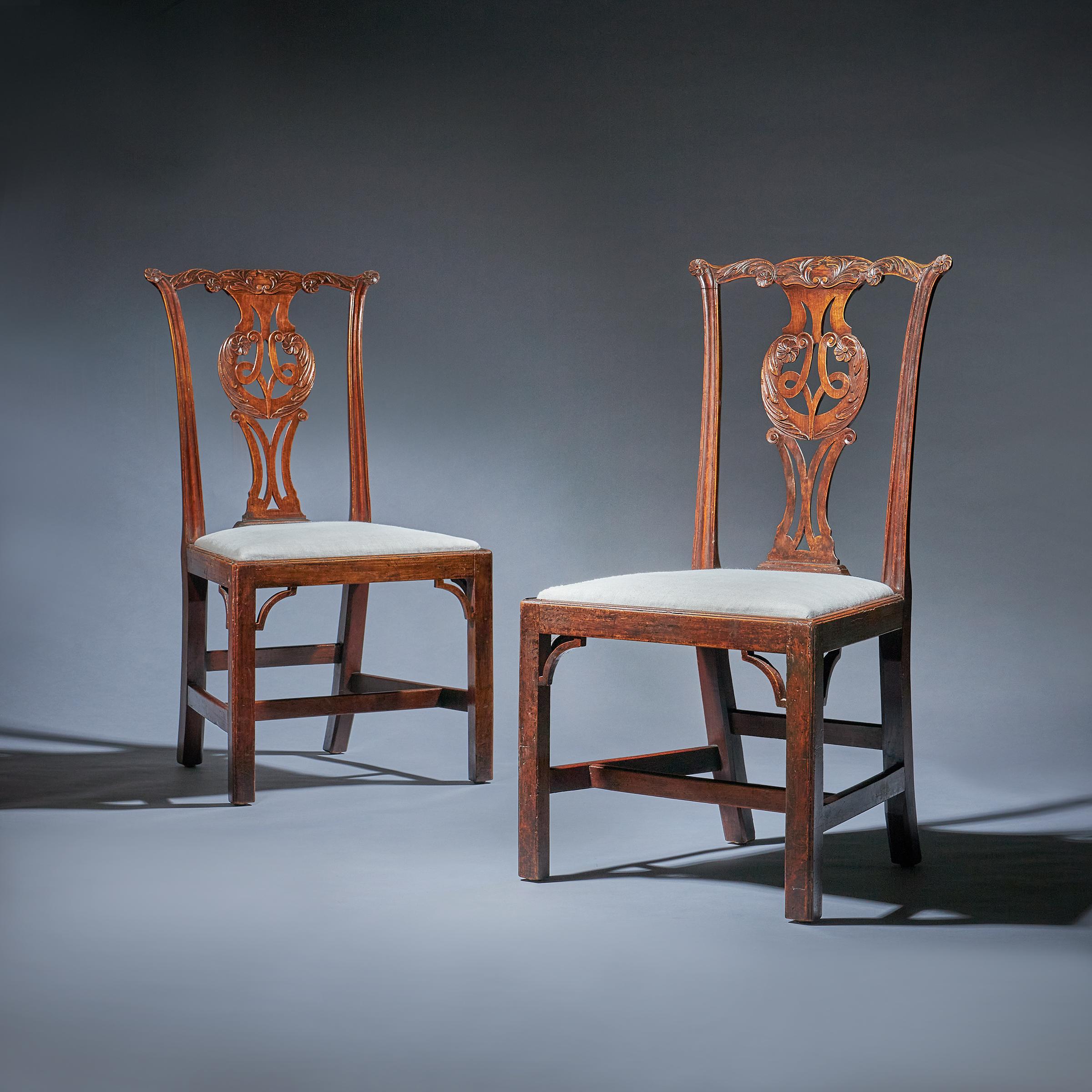 A fabulous and rare pair of George III cherry wood chairs in original 'Country House' Condition, Circa 1760-1770. 

The carved cresting rail is decorated with soft sweeping carved acanthus leaves and centred by a cartouche. 

The splat, of