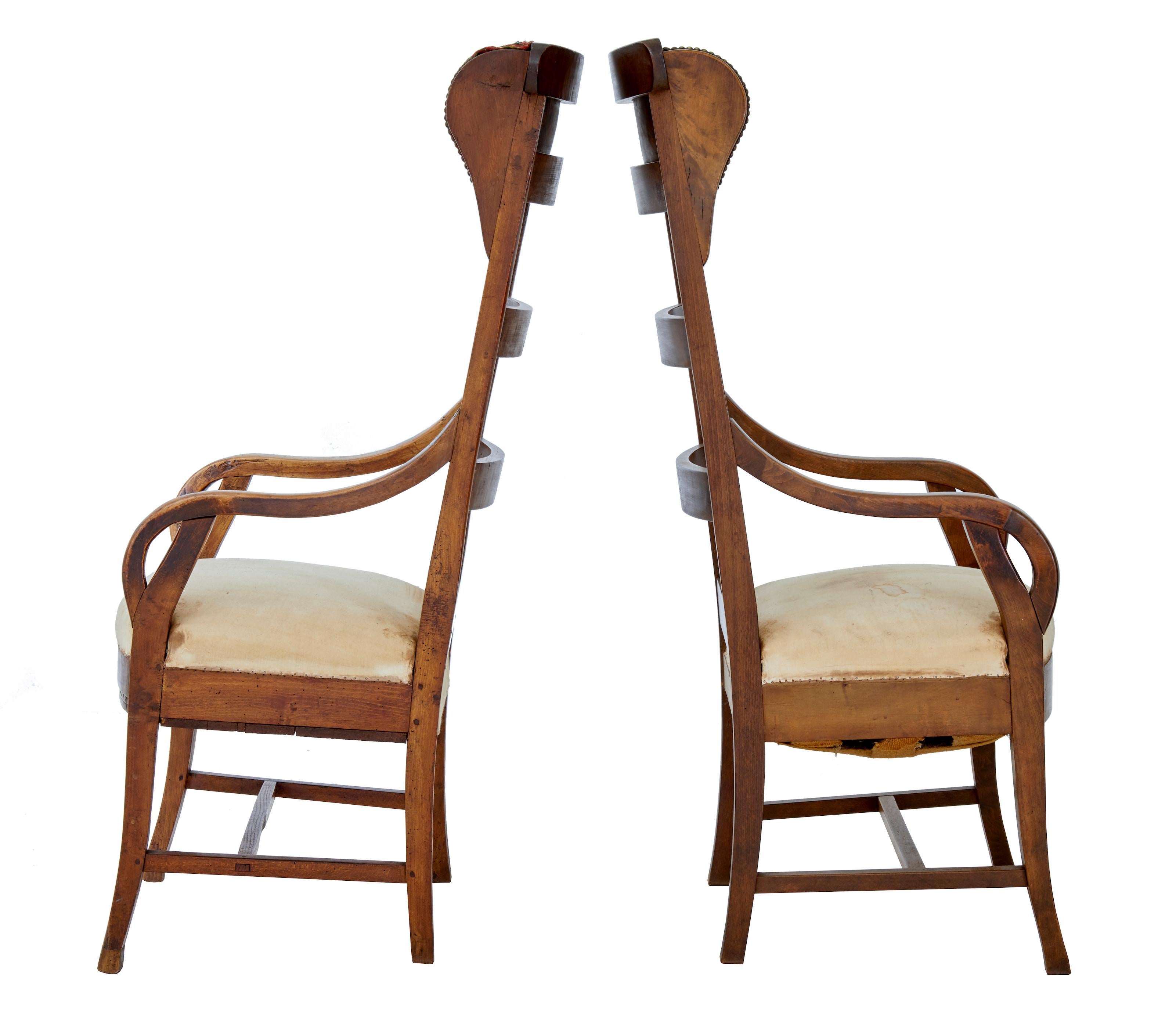 Unusual pair of 19th century fruitwood high back armchairs, circa 1880.

High back and wingback these shaped ladder back chairs are made from fruitwood. Lacking covering to seats and head rests in need of replacement. Ideal for use in a hall /