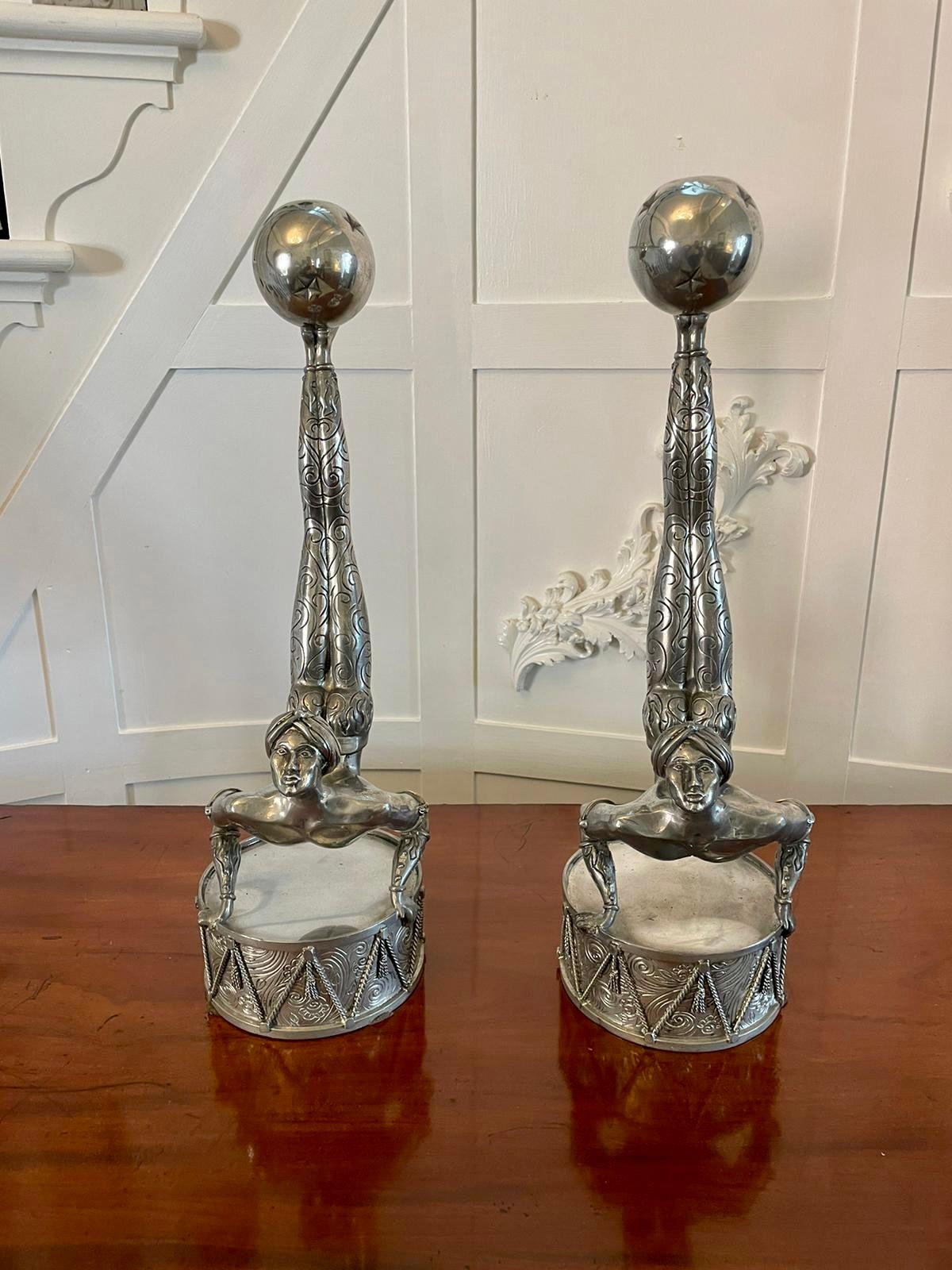 Unusual Pair of antique quality Art Deco silver plated candlesticks having a circus acrobat balancing a ball candle holder on his feet holding onto an ornate drum 

A charming pair having a splendid and unusual design

Measures: H 49.5cm x W