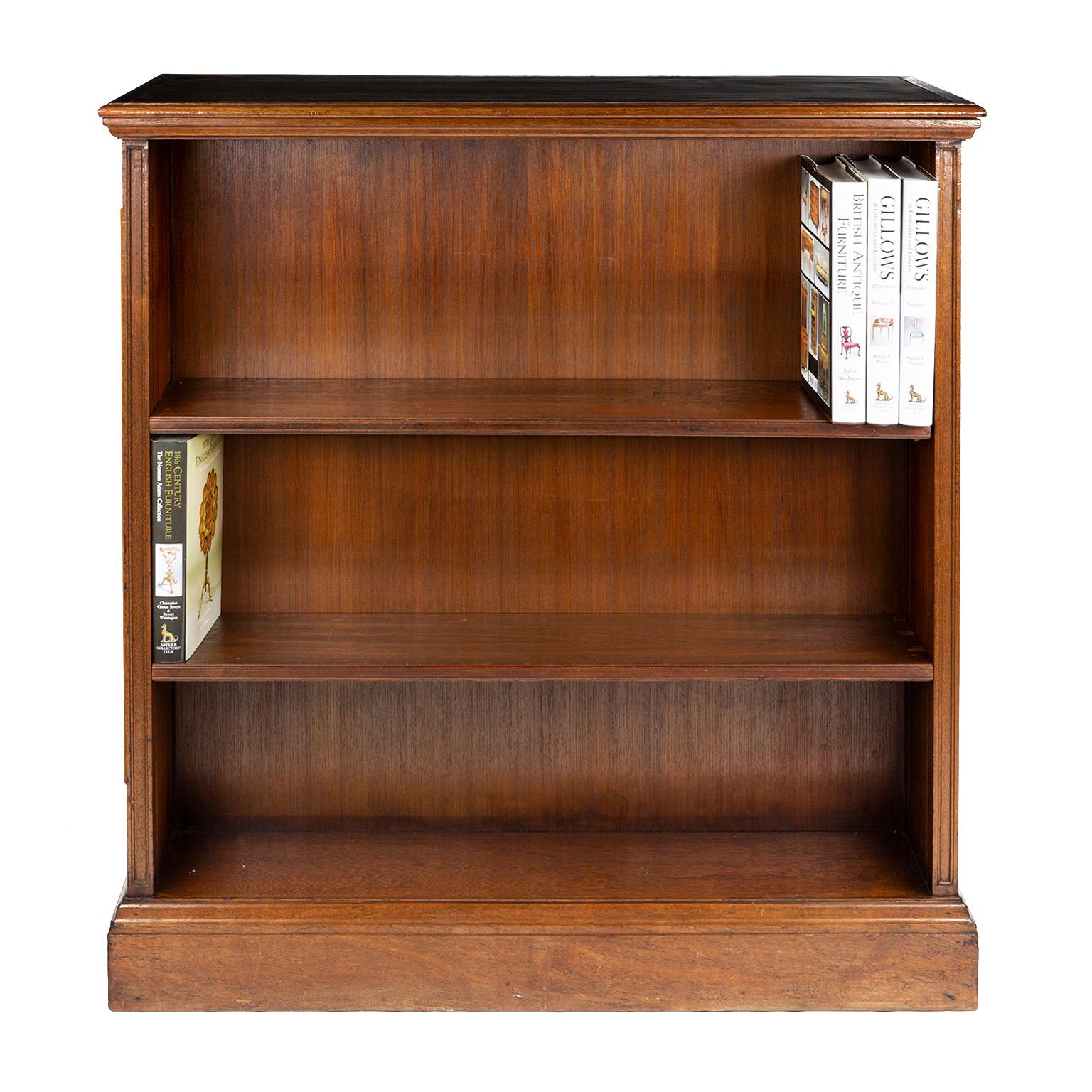 An unusual pair of double sided oak bookcases with brown leather tops. These have been designed to form a low level room divider with access to books on each side. They would normally be positioned across a room one either side, presumably with