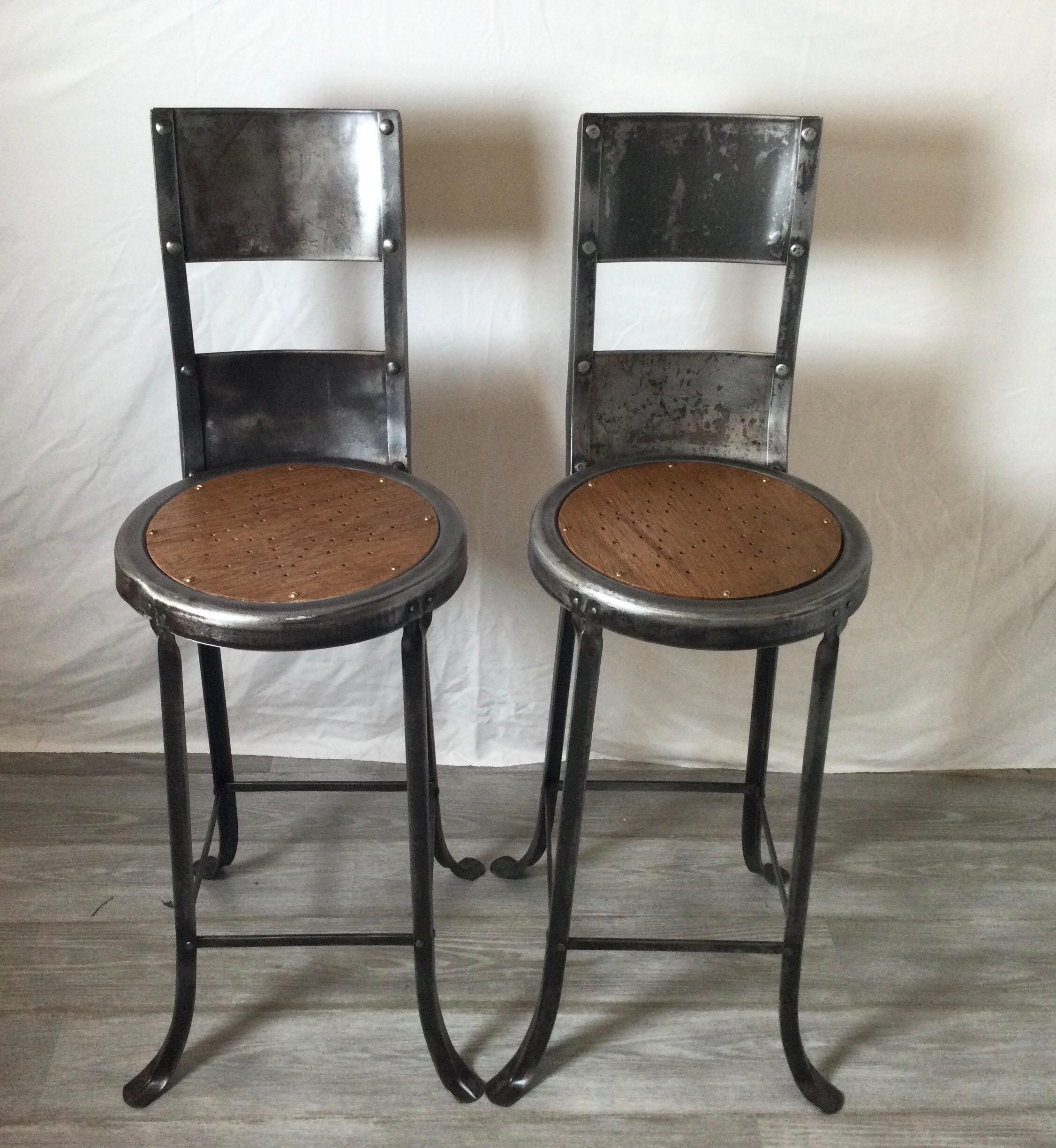 Beautifully designed and unusual. These great looking high back metal and wood stools are sold as a pair. Metal has been polished to a nice soft sheen, wood seats have a star design and are comfortable. Age appropriate wear. Seats have been replaced