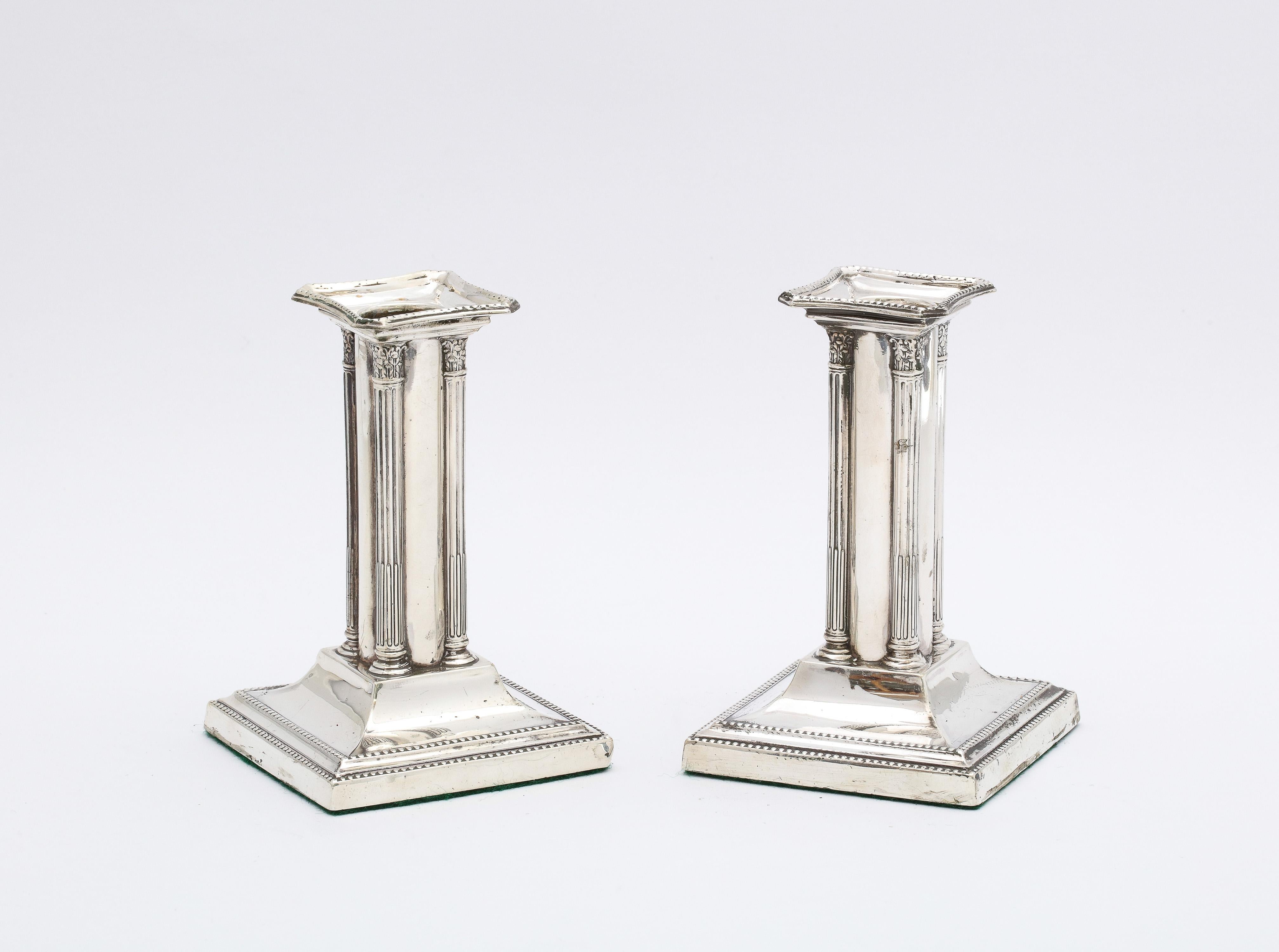 Unusual short  pair of Edwardian Period, Neoclassical-style sterling silver candlesticks, Sheffield, England, year-hallmarked for 1904, Thomas Bradbury and Sons, Ltd. - makers. Each candlestick measures 3 3/4 inches high x 2 1/4 inches wide (at