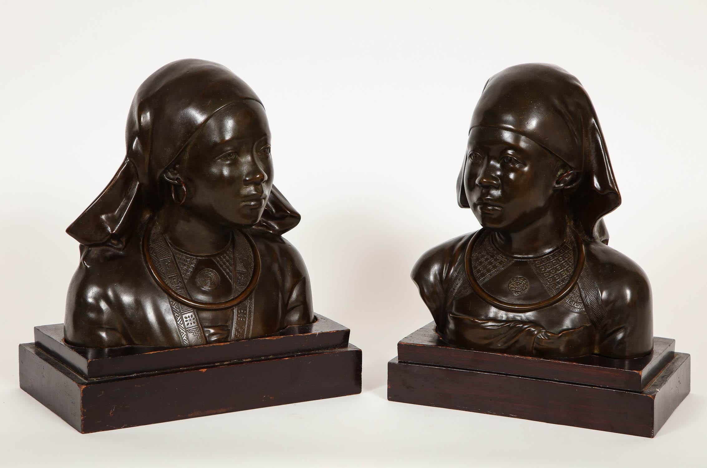 Unusual Pair of French Japonism Bronze Busts of Girls.  This unique pair of patinated bronze busts exemplifies fine hand-crafted craftsmanship of the highest degree.  Each girl is immensely detailed from her headwear, to the facial features, as well