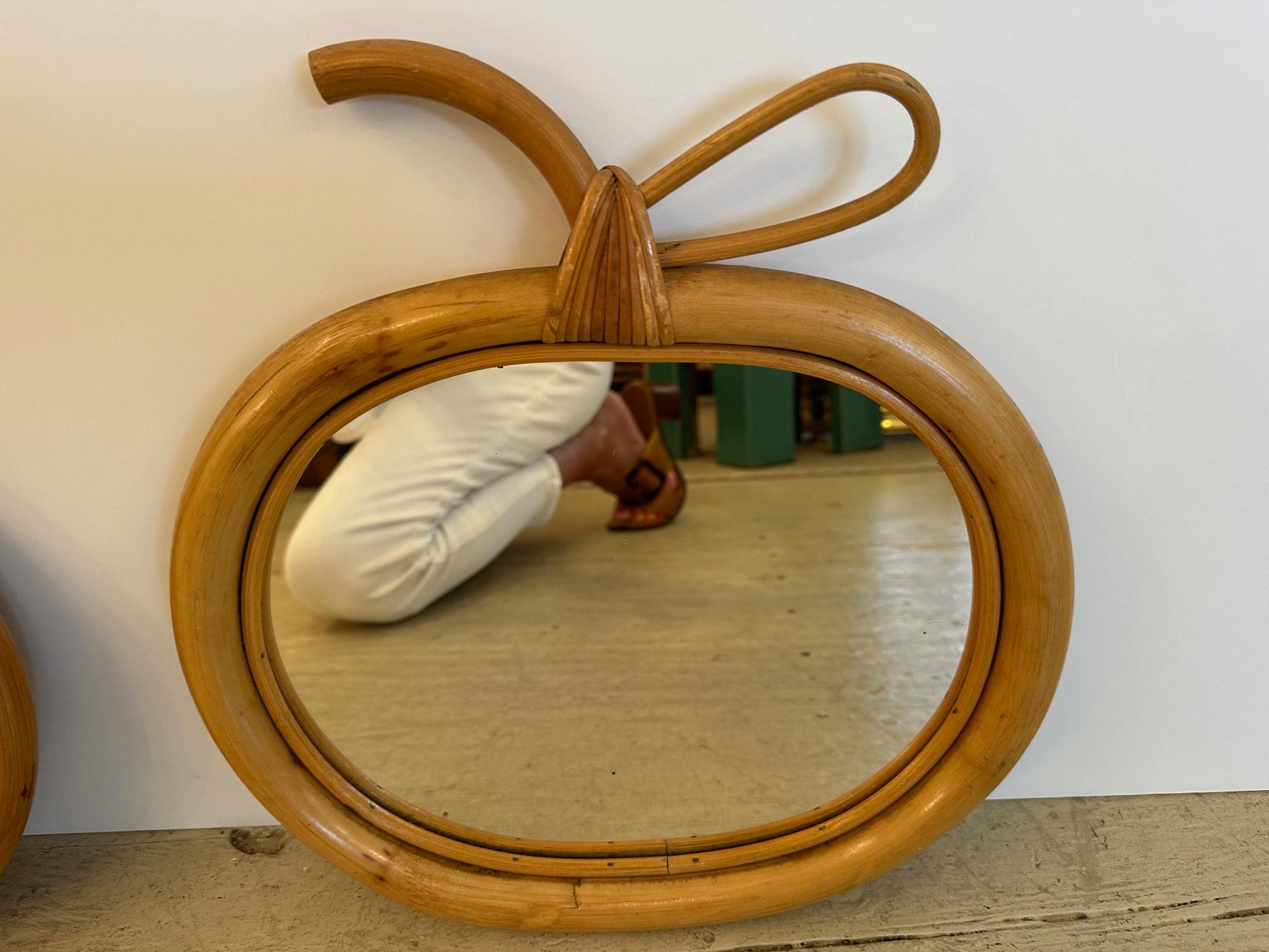 Pair of French mid century rattan and wicker apple form mirrors.

