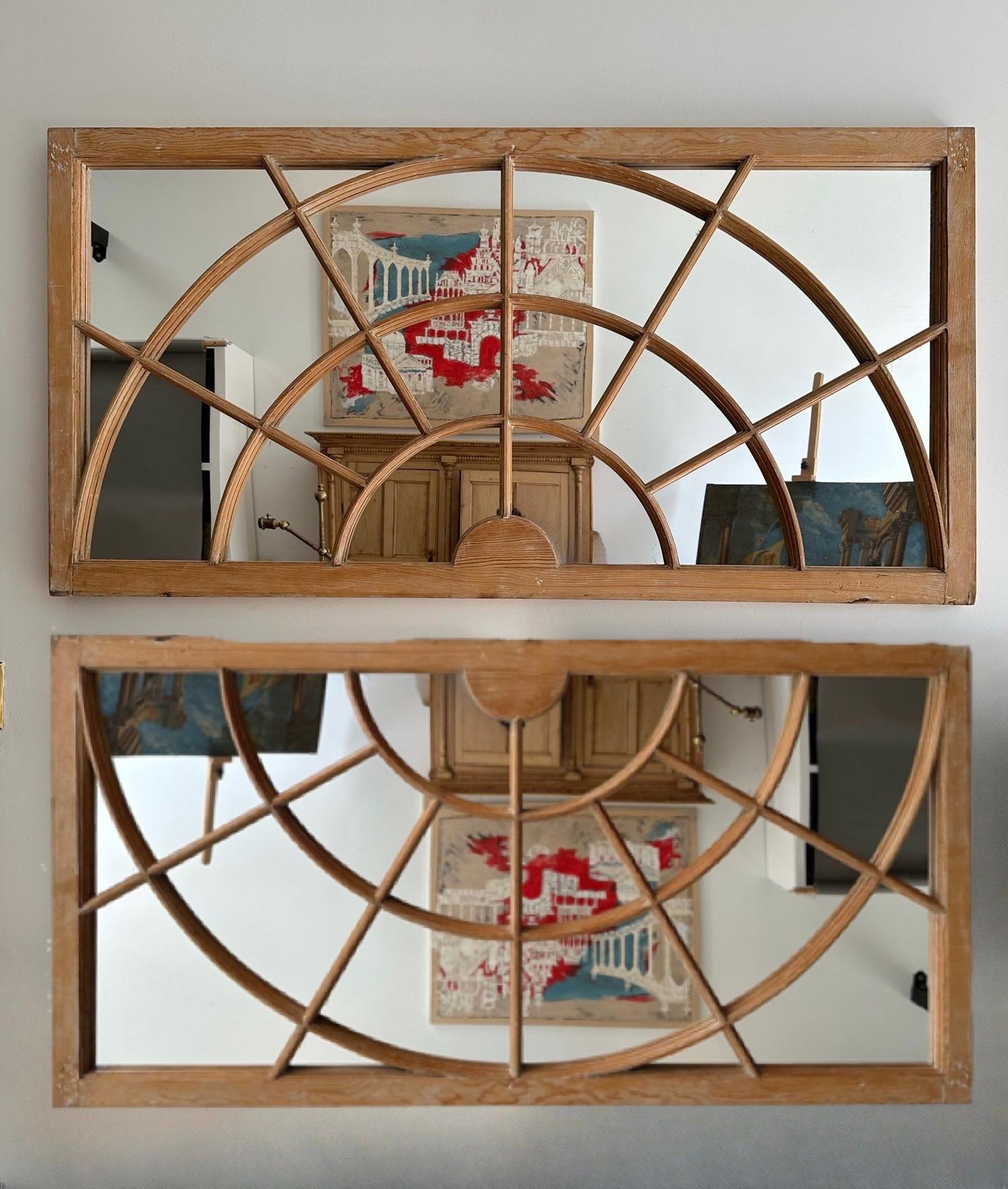 Unusual Pair of Georgian Styled Transom Windows Converted to Mirrors. Constructed of Pine with Arched Moulded Mullions and custom mirror panels. Made in Virginia circa 1850