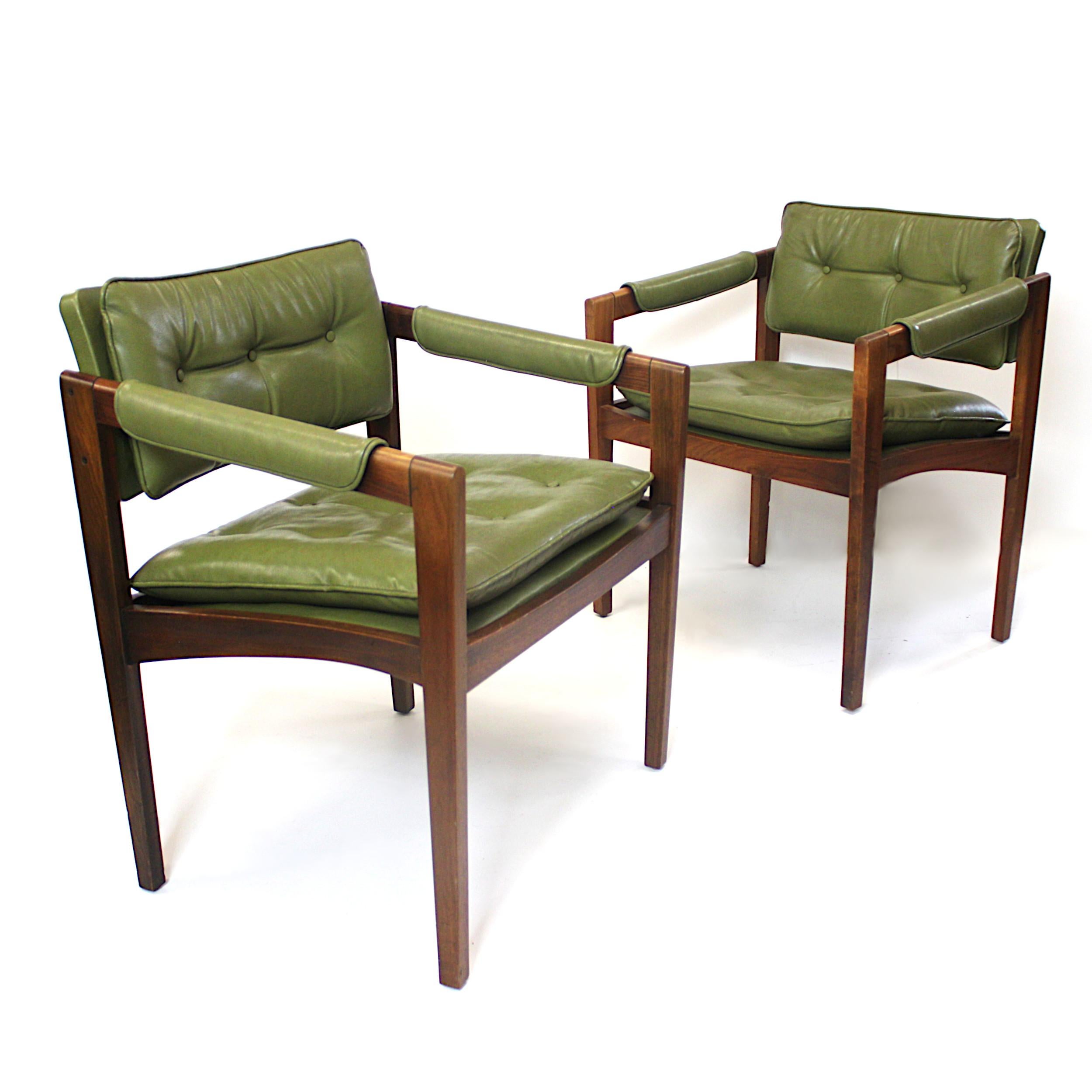 This unusual pair of side chairs by Glenn of California feature beautifully sculpted, solid walnut frames with wonderful tufted green vinyl upholstery. Chairs are in spectacular original condition and even still retain their original dated tag of