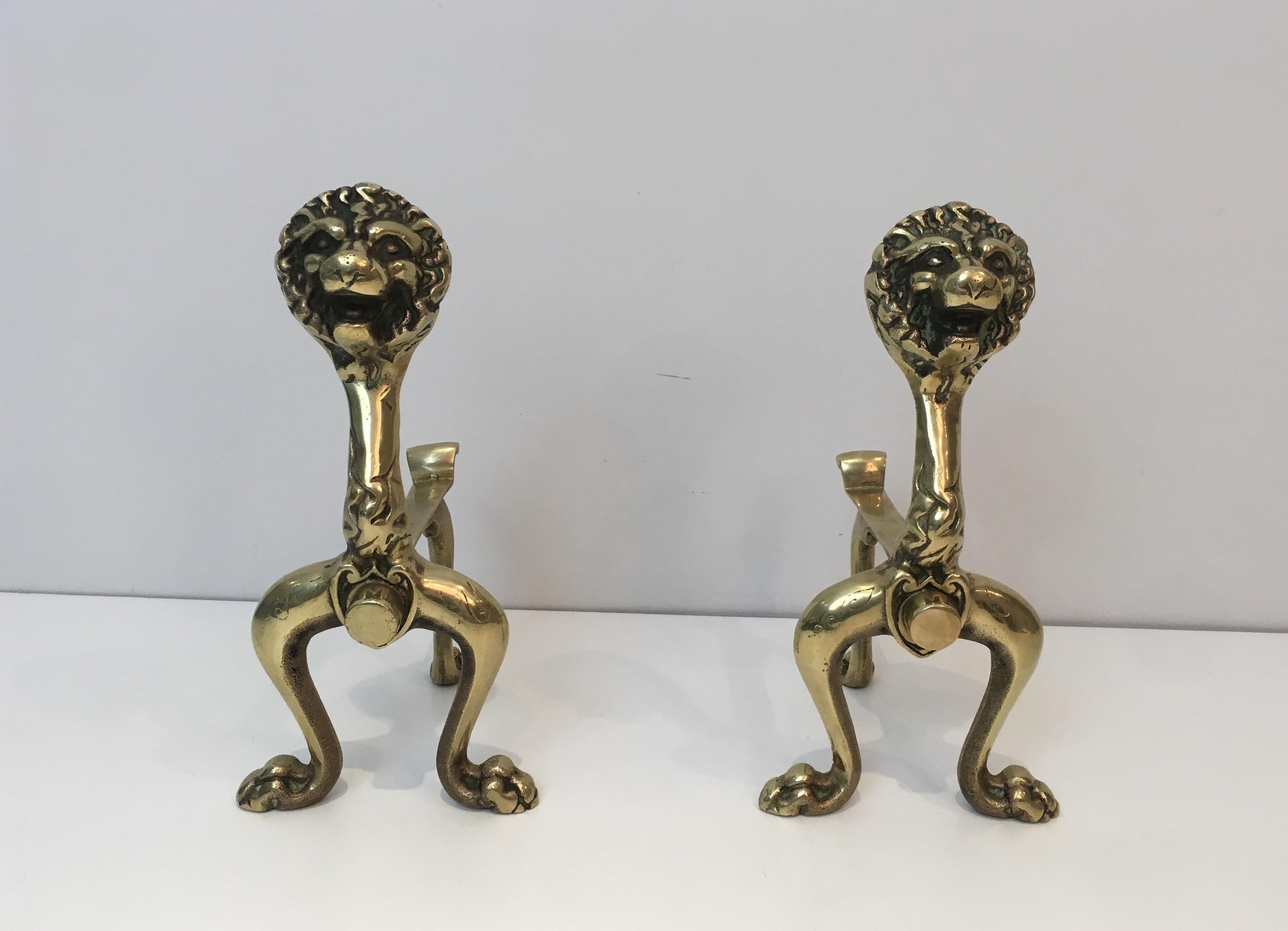 This unusual pair of decorative andirons is made of bronze lions. This is a French work, circa 1900.