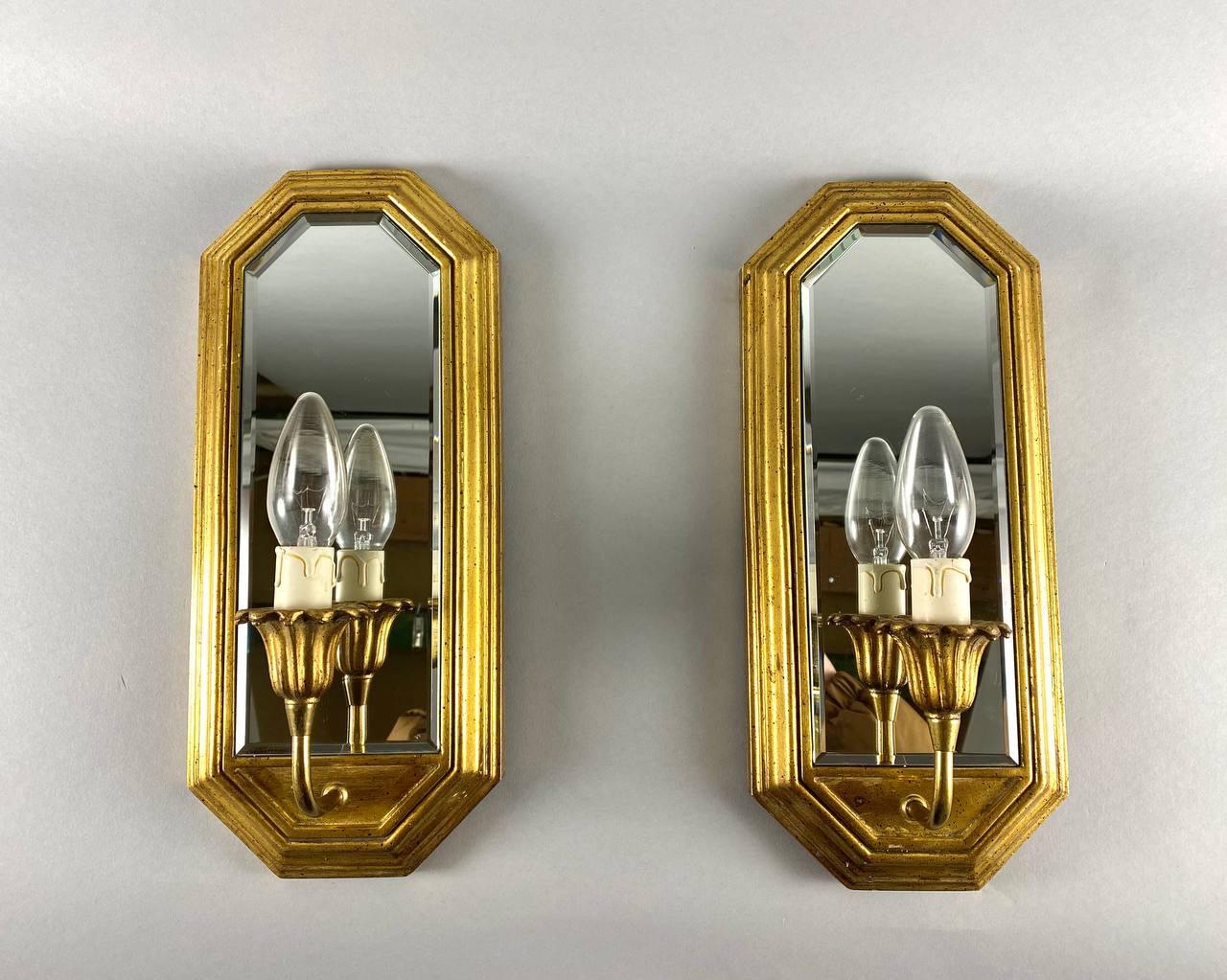An Incredible set of 2 Wall Mirrors Sconces in gilded and polished brass and wood, created by the famous design house Deknudt, Belgium. 

 Dating from the second half of 20th century.

 The wall lamps are great for creating a cozy and soothing