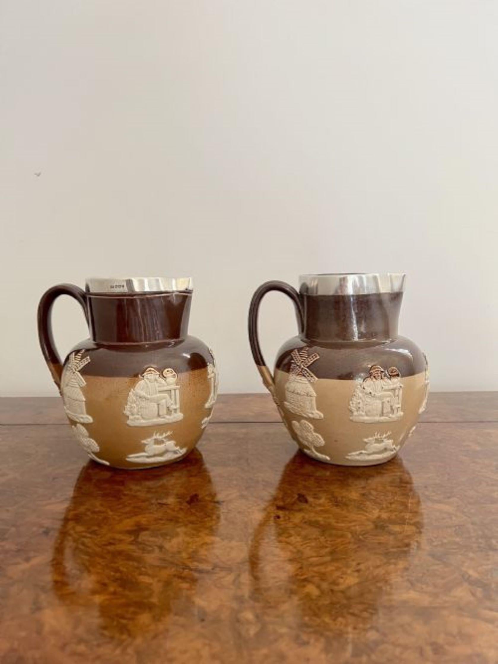 Unusual pair of quality antique Doulton Lambeth harvest jugs having a quality pair of Doulton Lambeth harvest jugs having a two tone brown background decorated throughout with hunting scenes, figures and objects, a shaped handle to the back with