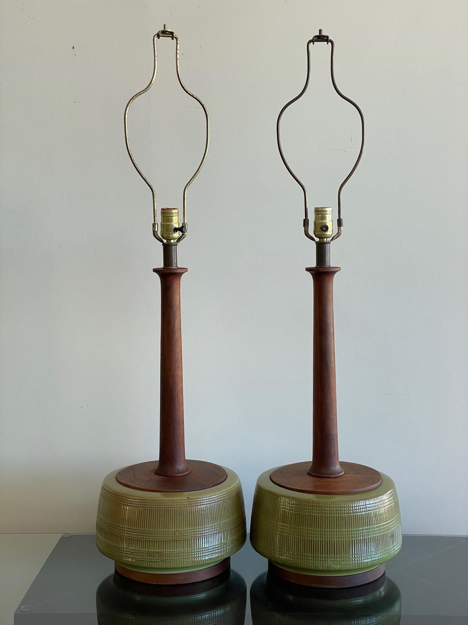 An unusual pair of ceramic lamps with elongated sculptural walnut stems, in the style of Martz. Measuring approx. 10.5