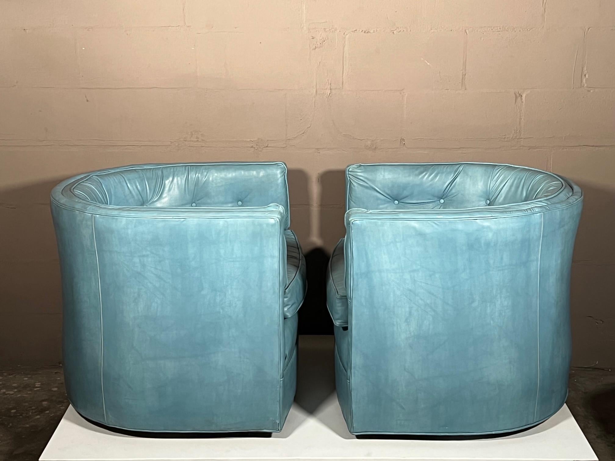 A great pair of unusual, low profile, tub or barrel chairs with swivel bases. Practical and not too big these chairs go well with modern or traditional interior.