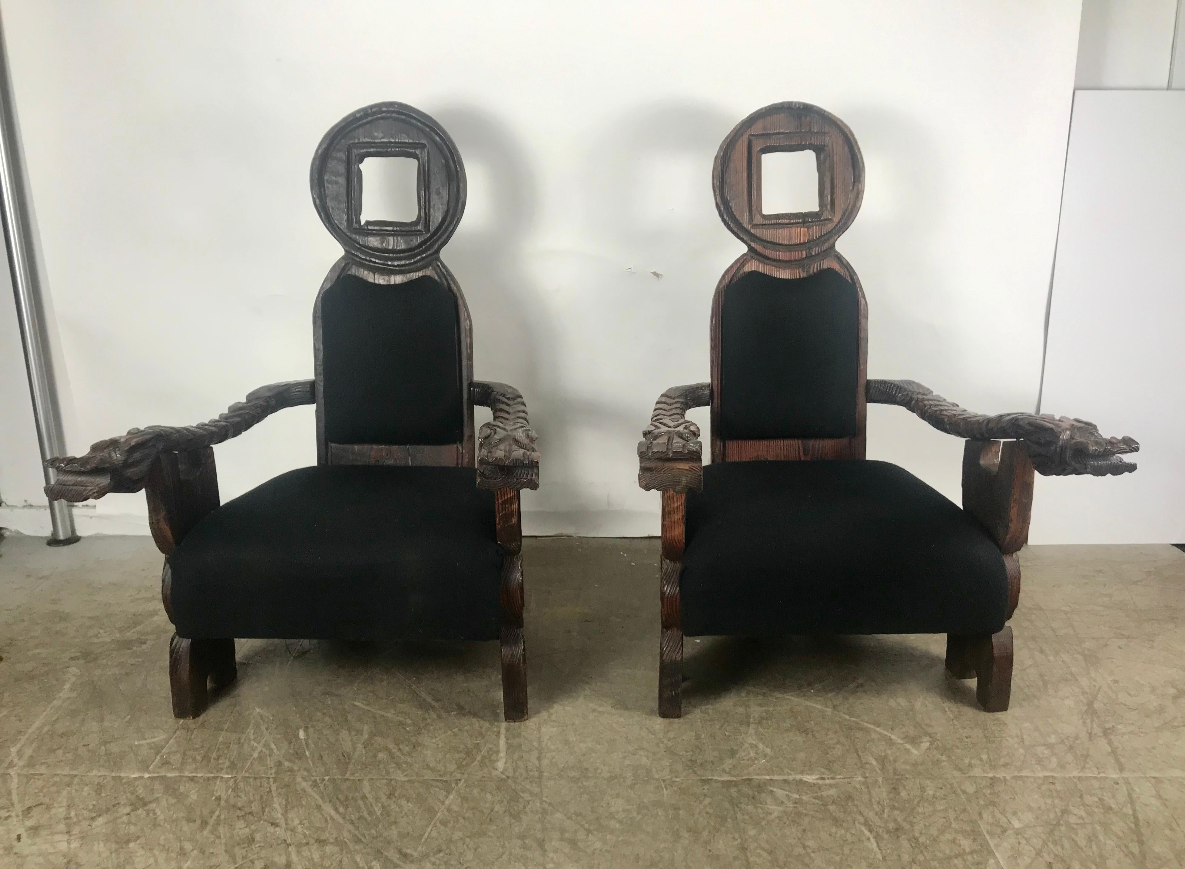 Unusual pair oversized, Teki Modern lounge chairs by William Westenhaver for Witco, definitely over the top, same chairs can be seen in Elvis Presley's Graceland. Crazy carved walnut, gargoyle design, retains original Witco tag, hand delivery avail