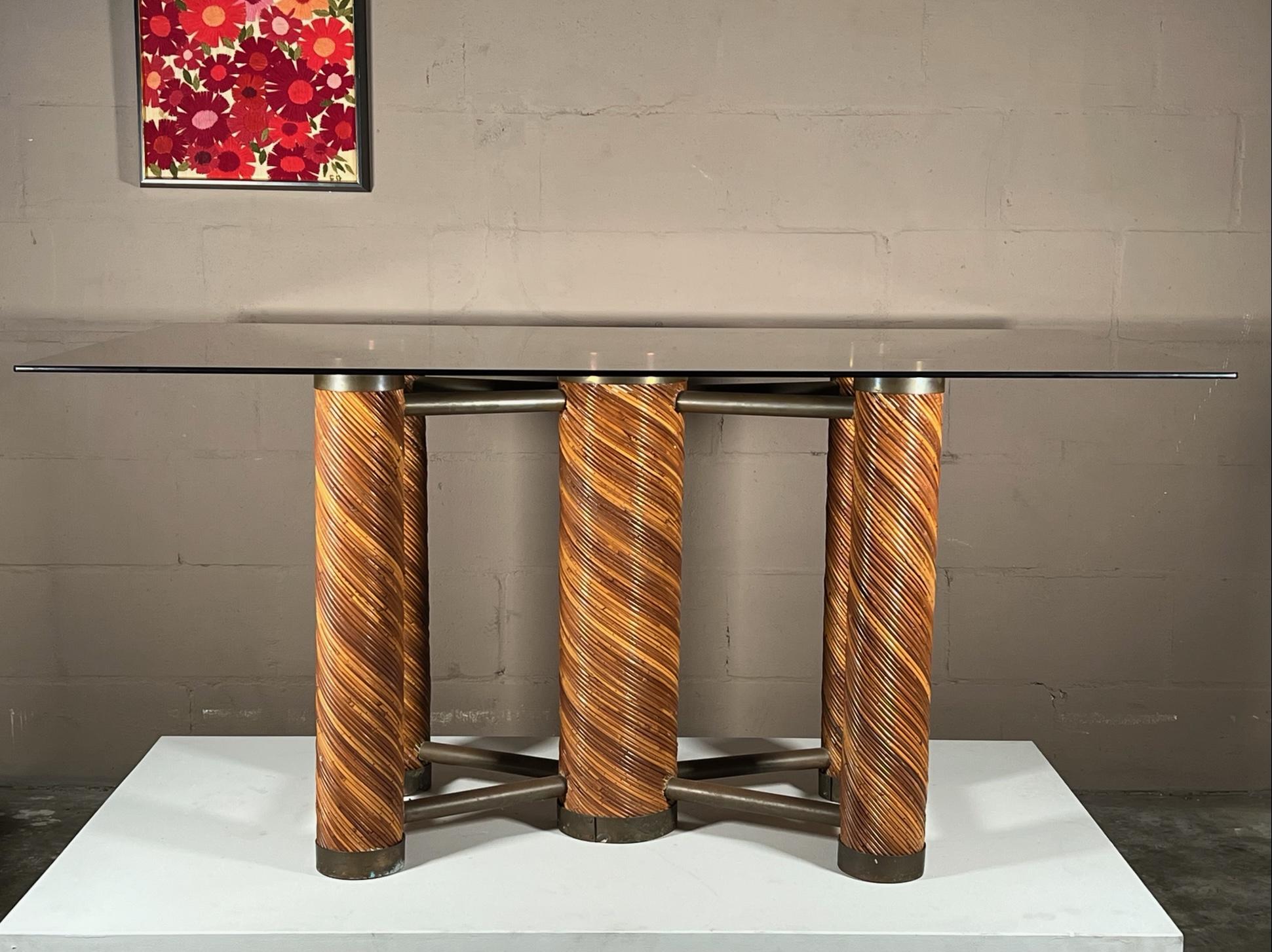 Unusual and rare table. Pencil reed/bamboo with brass, heavy and well made ca' 1970's. Could be a dining table or with smaller piece of glass a console table. Has a great futuristic 1970's atomic look. Base alone measures 34