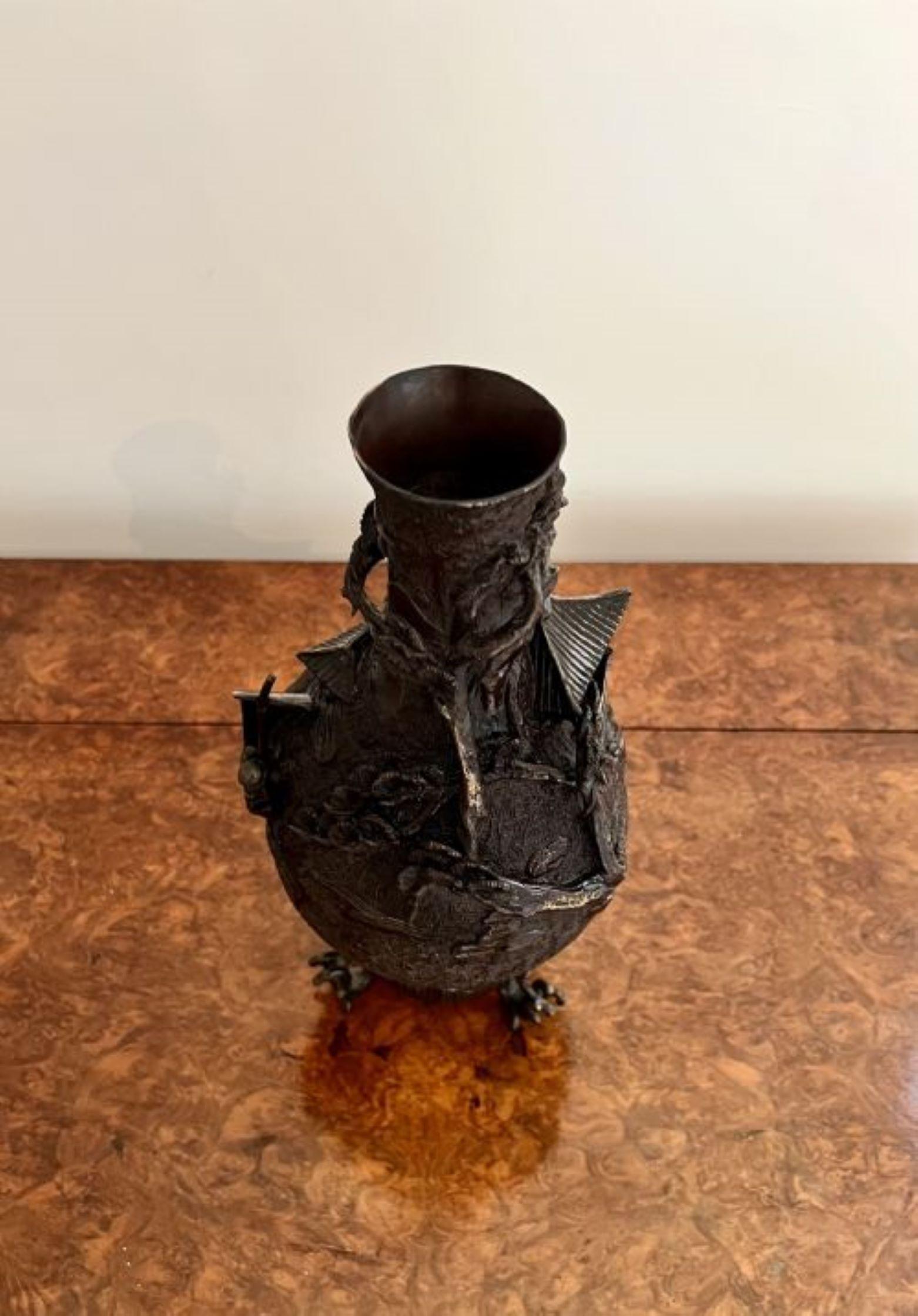 Unusual quality antique Japanese bronze vase having an unusual quality antique Japanese vase decorated in relief with a sailing boat, houses and foliage, raised on three scroll feet, Meiji period