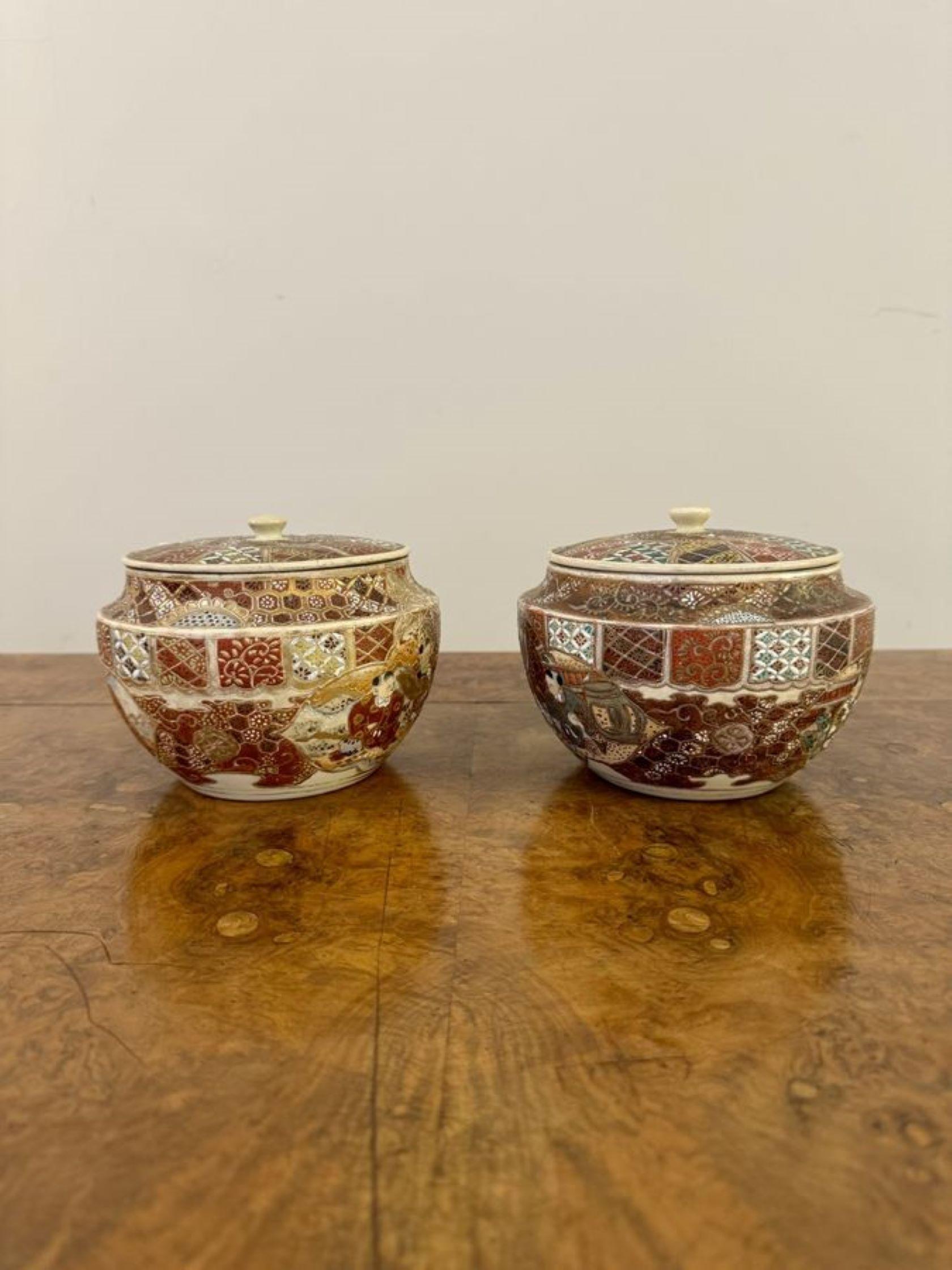 Unusual quality pair of antique Japanese Satsuma lidded jars, having two antique Satsuma lidded jars, decorated with traditional Japanese figural scenes hand painted in stunning red, gold, white, green, blue and brown colours. 

D. 1900