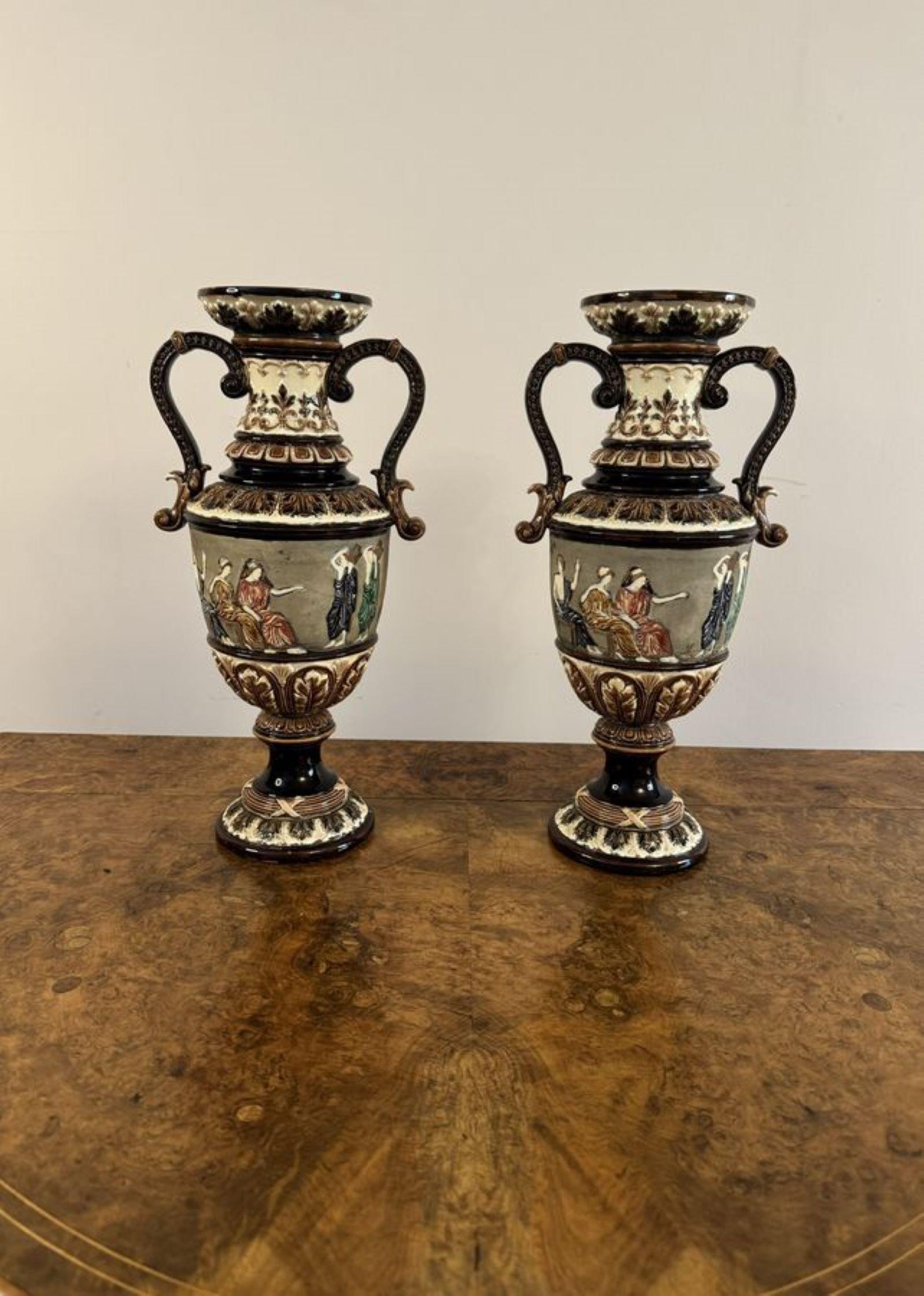 Unusual quality pair of antique Victorian vases having a quality pair of antique Victorian vases, decorated with figures, scrolls, flowers and leaves hand painted in stunning brown, green, blue colours, having a fluted shaped neck, twin shaped