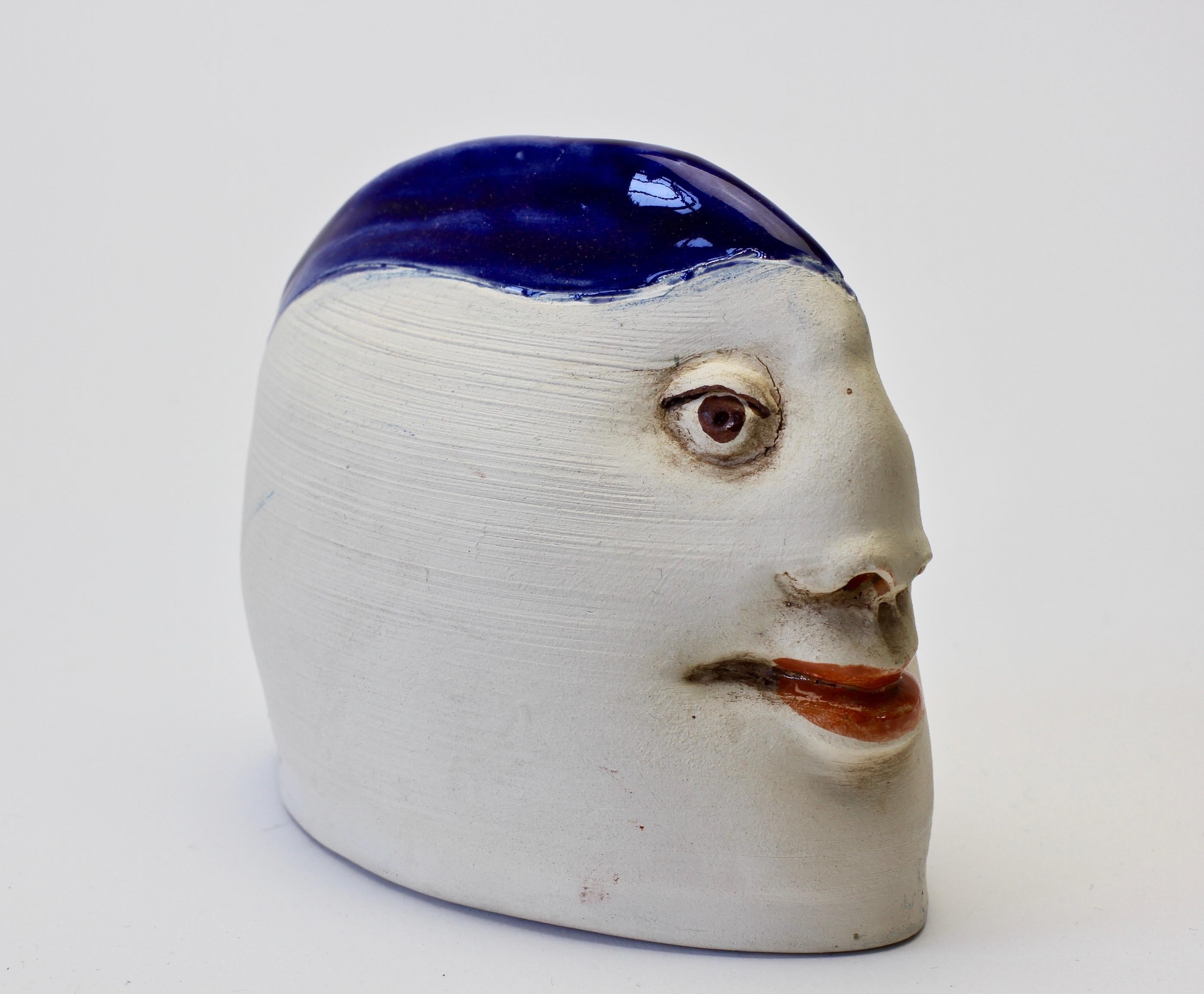 Delightful little vintage ceramic pottery of a head with extraordinary / unusual facial features with a cobalt blue glazed hat and bright red lips, made circa 1980s. Although this piece is signed we have yet been able to identify its maker. There is