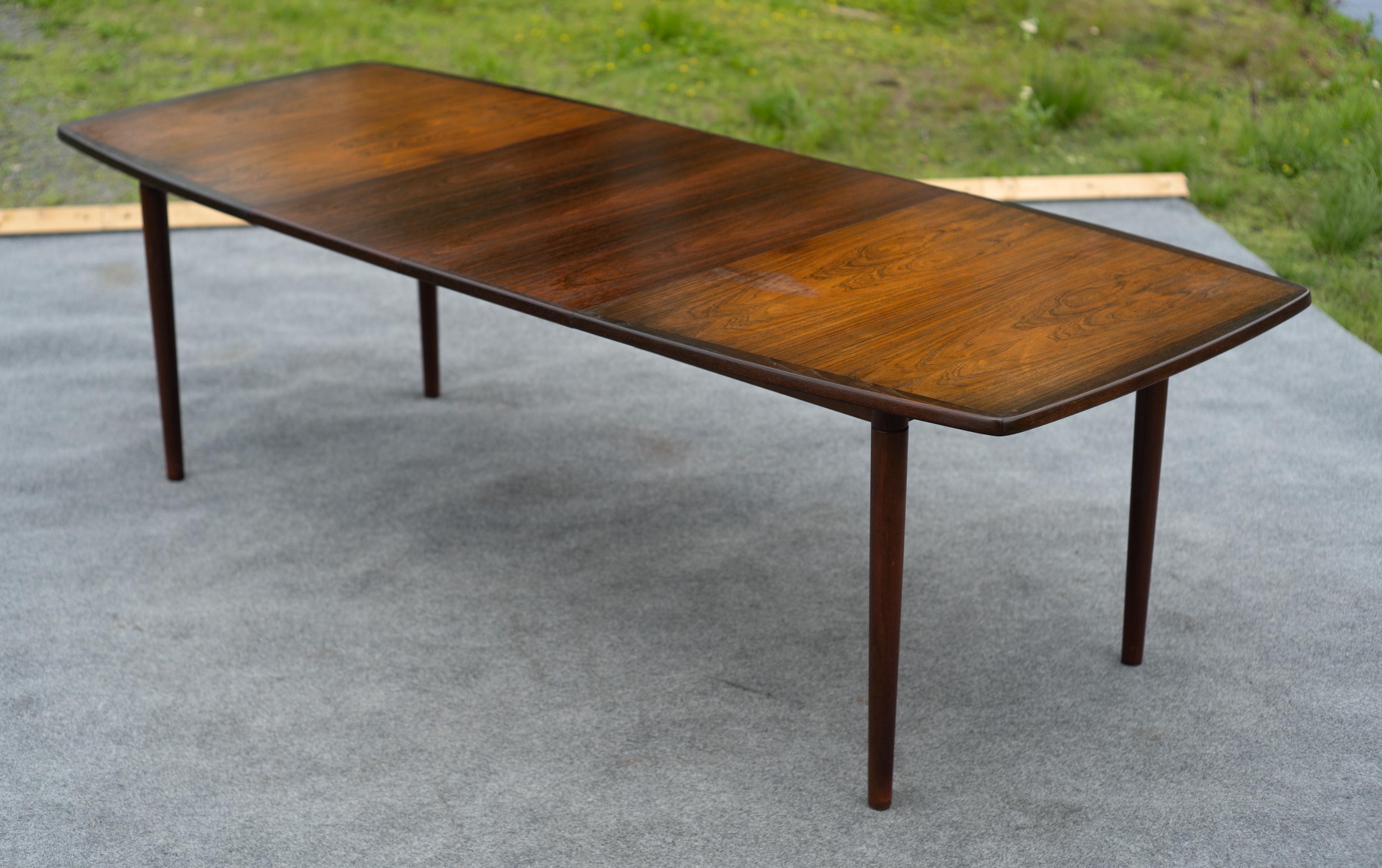 Designed and made in Norway, this dining table features a wonderful combination of great Norwegian design and awesome production quality. With frame made of walnut hardwood, it features a solid walnut edge trim, solid turned legs, and hardwood