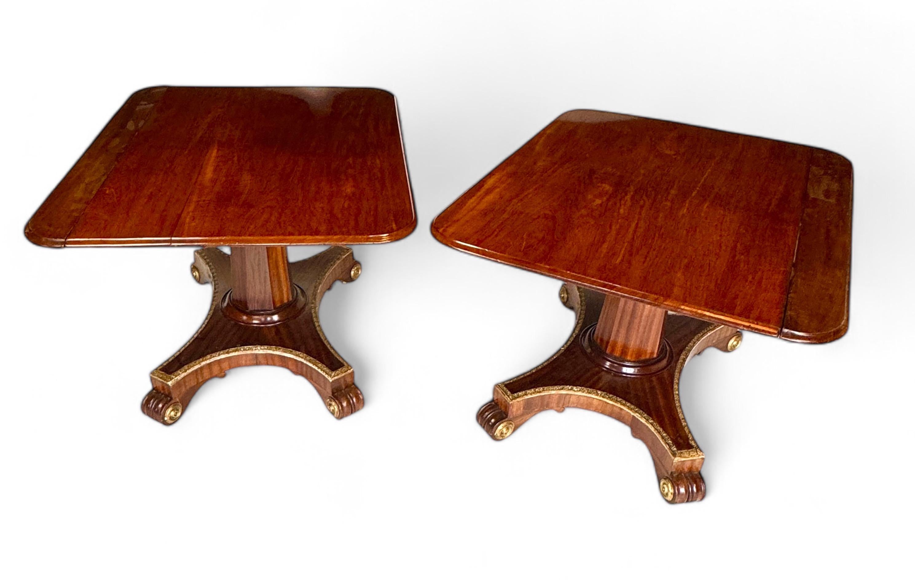 English Unusual Regency twin pedestal mahogany and parcel gilt dining table