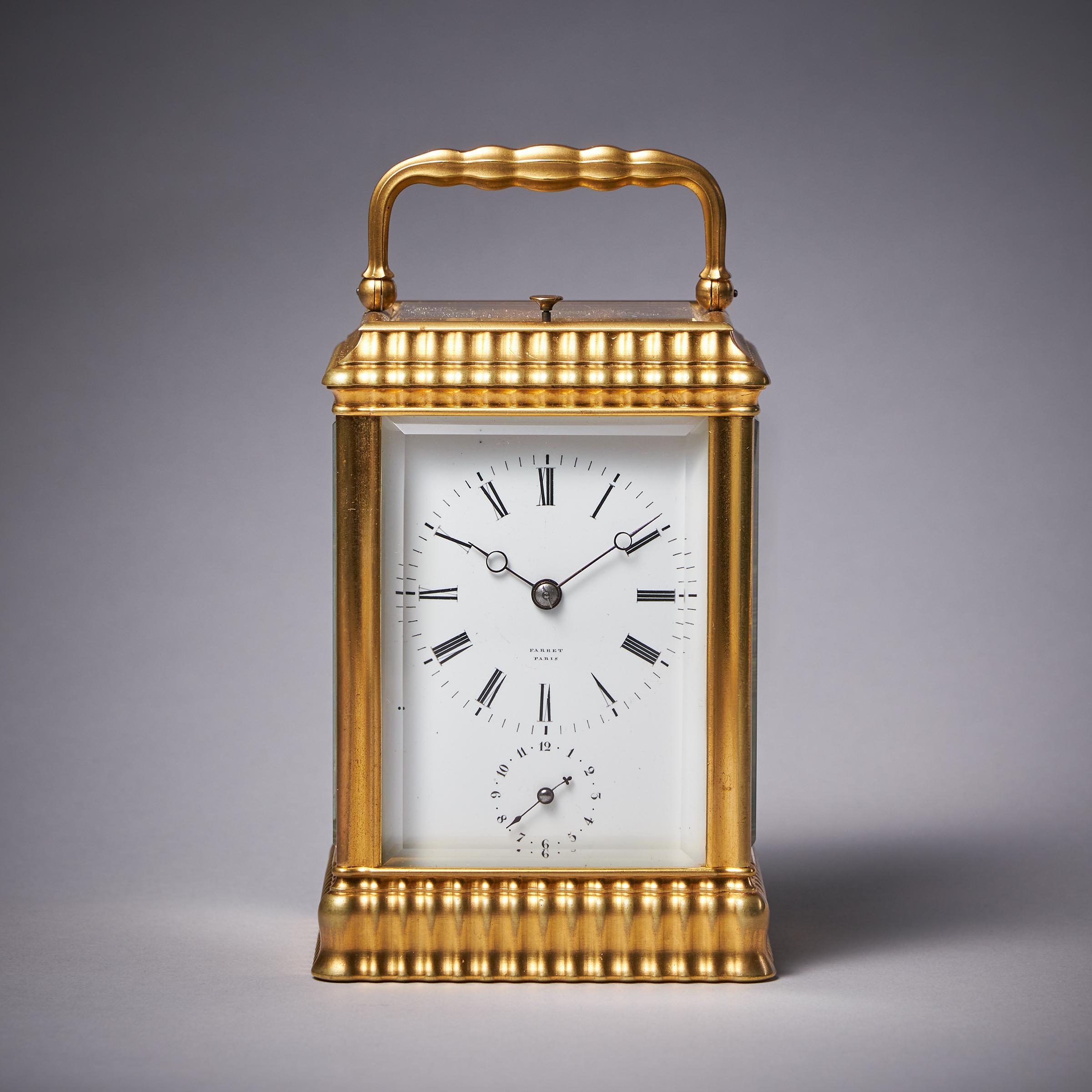 Case
The clock has a gilt-brass case which is a variation on the gorge case in that the top and bottom are ribbed, which adds to its elegance. It has bevelled glass windows on all sides so that the movement is almost entirely visible. The gilt