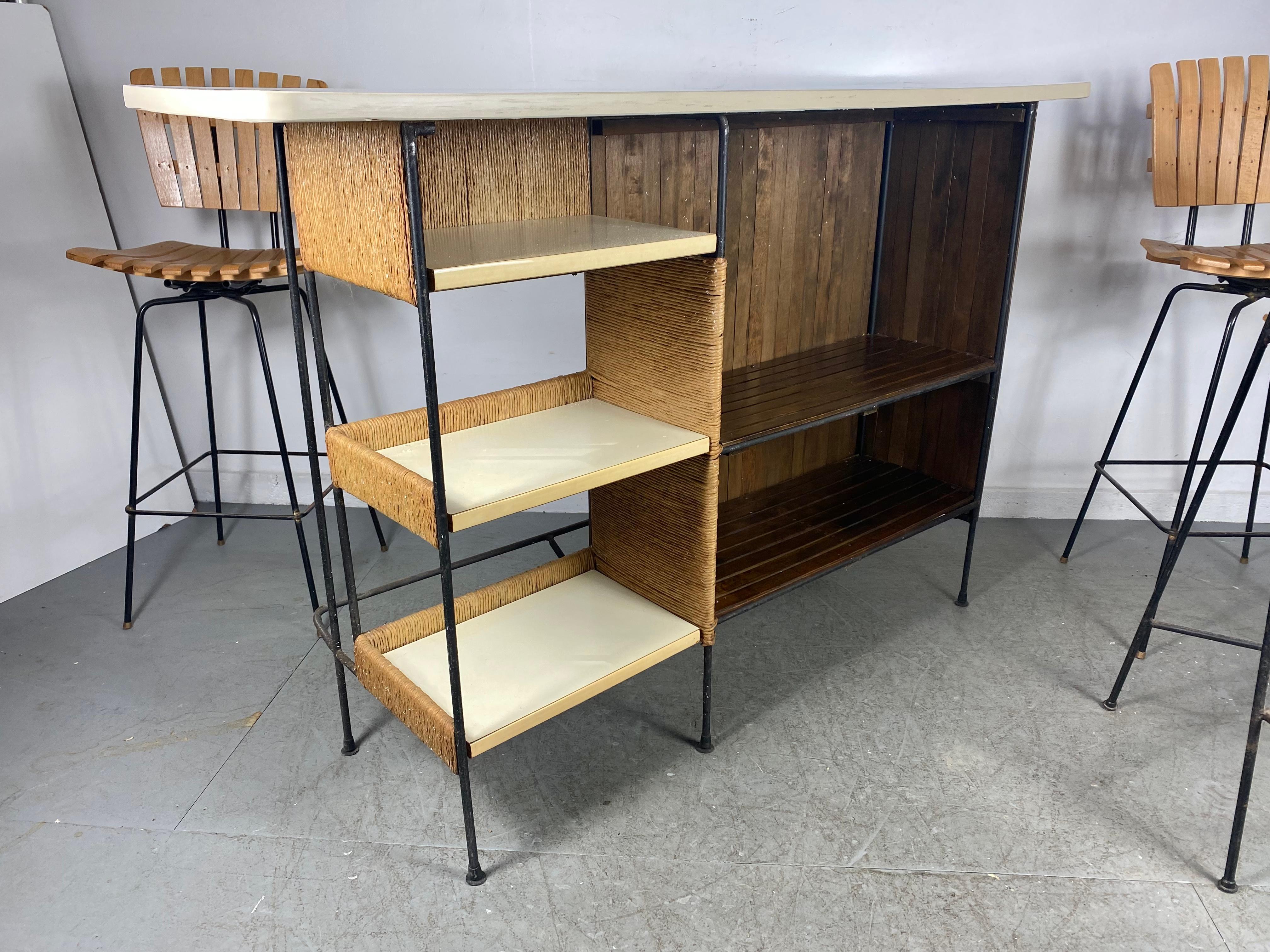 Unusual ,,seldom seen,, Home Bar with (1) matching stool designed by Arthur Umanoff. Please note. (2) slat wood stools pictured are not included ! This version rarely shows up on the market, Classic modernist design. Heavy iron frame, slatted wood