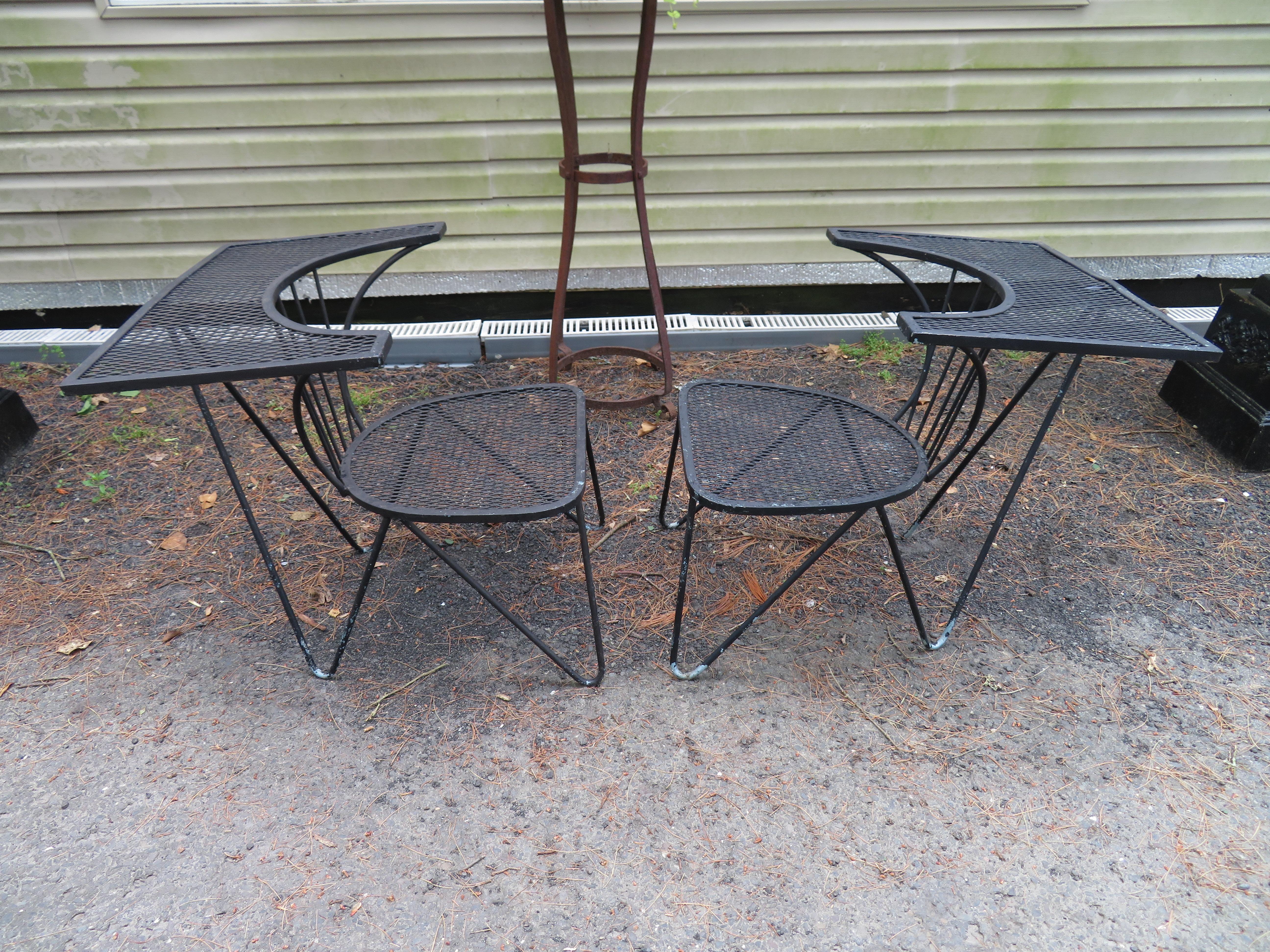 Unusual set of 4 geometric Salterini patio chairs with fabulous built in table. We have never seen another set of these so they must be quite rare. We just love the very unusual hairpin legs and the fun shaped built in mesh tables.