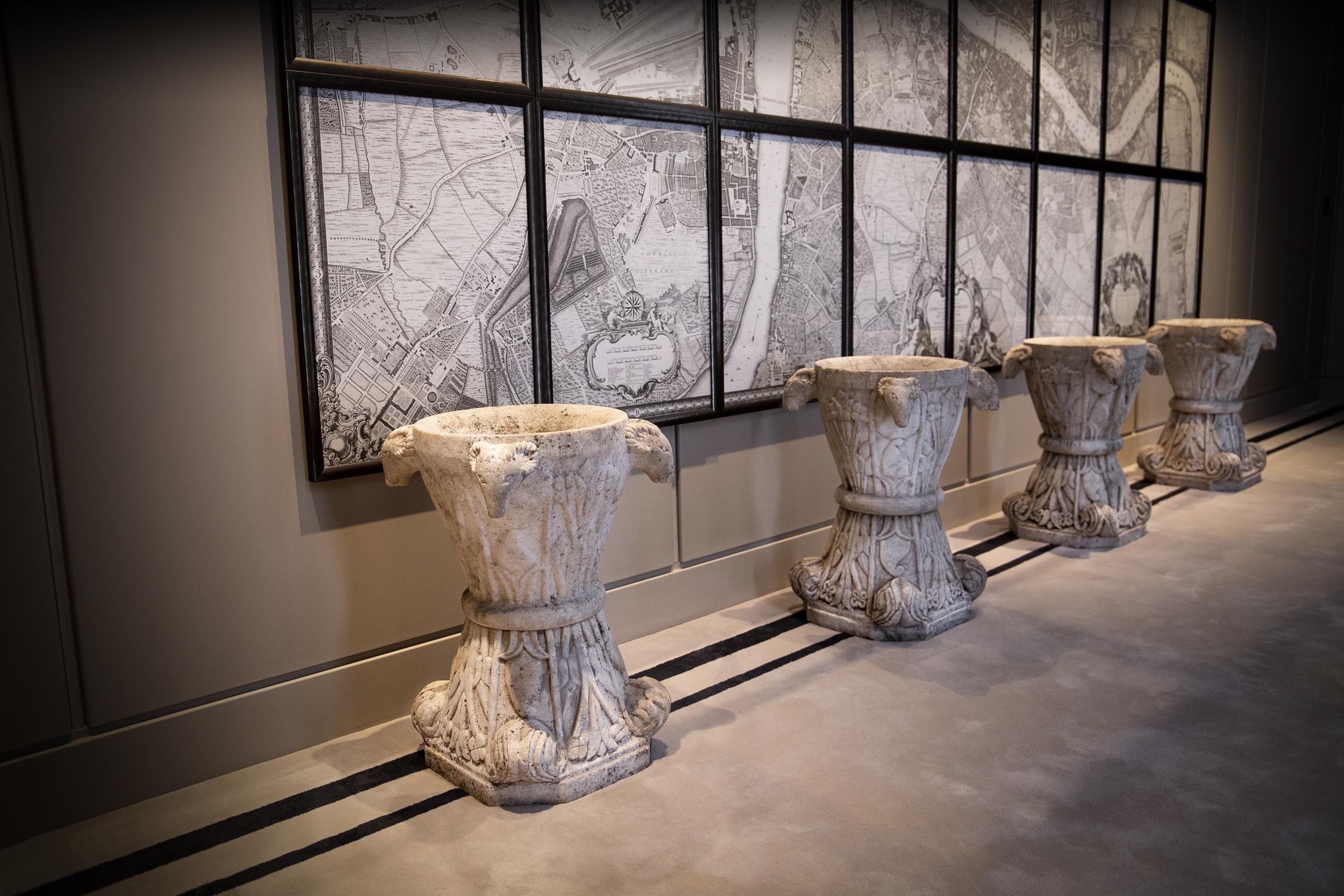 A real statement in a hallway, courtyard or conservatory, these are an exceptional and rare carved set of four Italian beautifully aged marble urns with 4 ram's heads at each corner. The removable top sections of tapering circular form, with