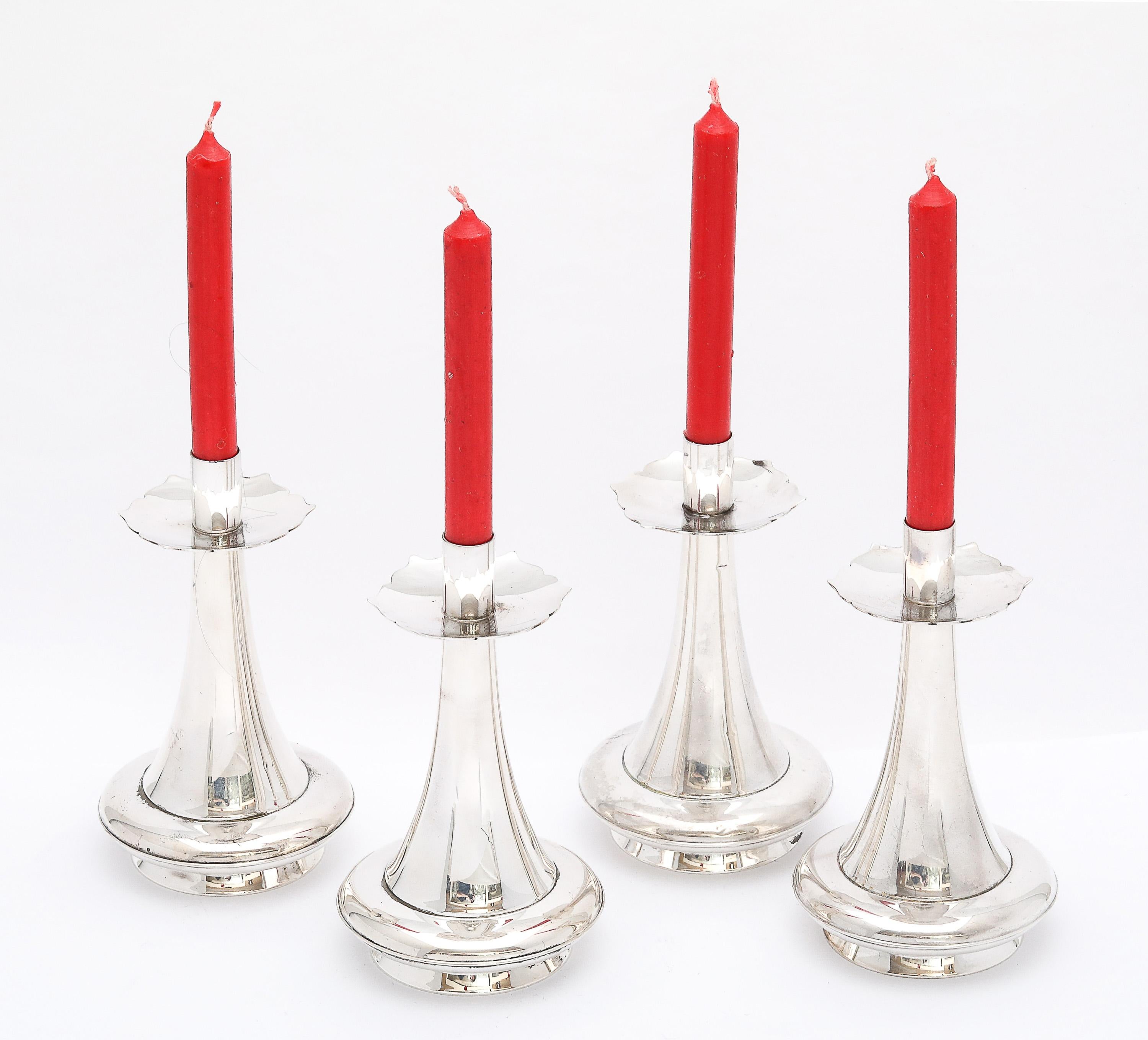Unusual set of four, sterling silver, Mid-Century Modern, graceful candlesticks, Gorham Manufacturing Company, Providence, Rhode Island, Ca. 1950's. Each candlestick measures 4 3/4 inches high x 2 3/4 inches diameter across its base. The