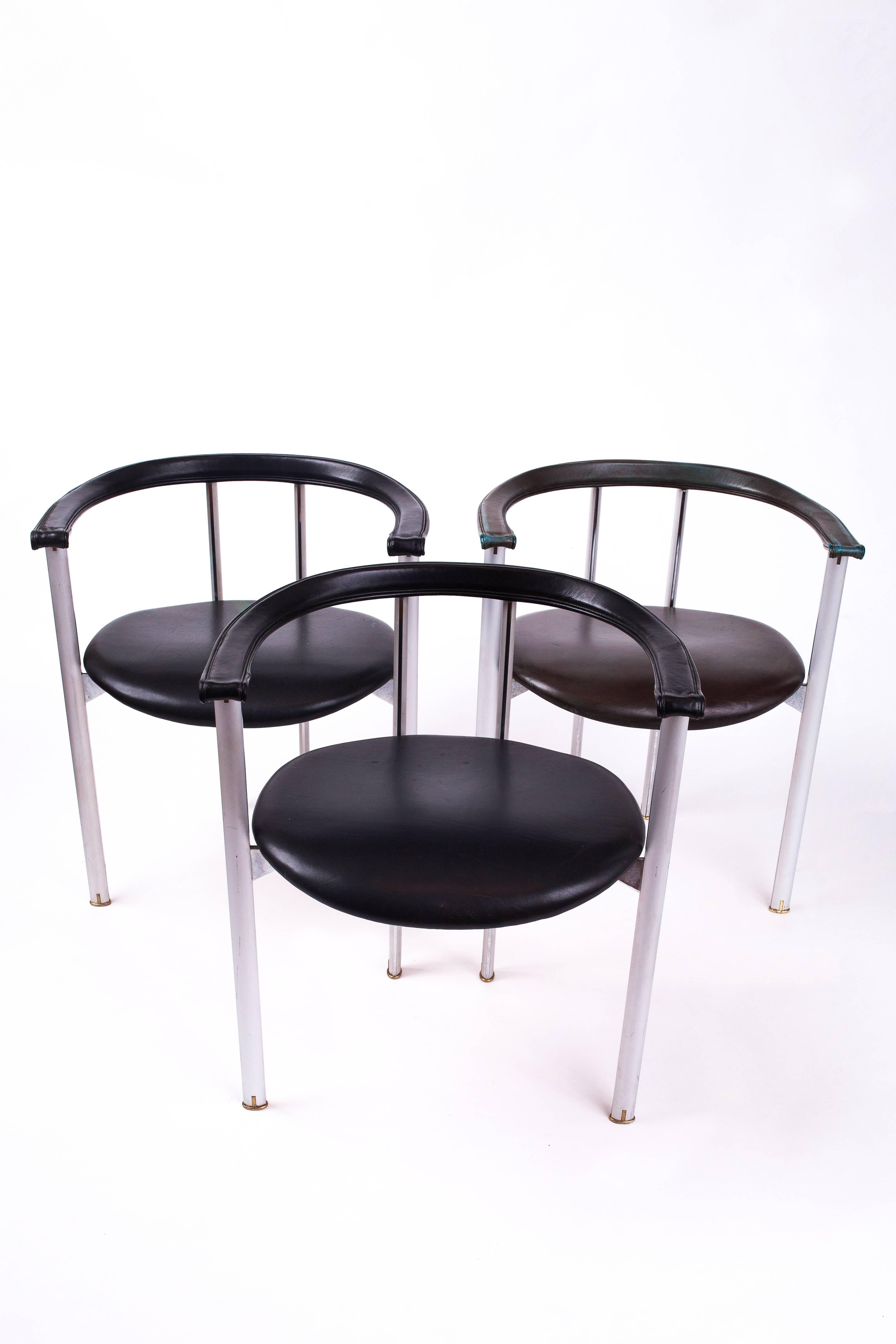 Antonio Citterio (b. 1950)

A striking set of three unusual minimalist steel and black leather armchairs by Antonio Citterio for B & B Italia, reminiscent of Luigi Caccia Dominioni's 