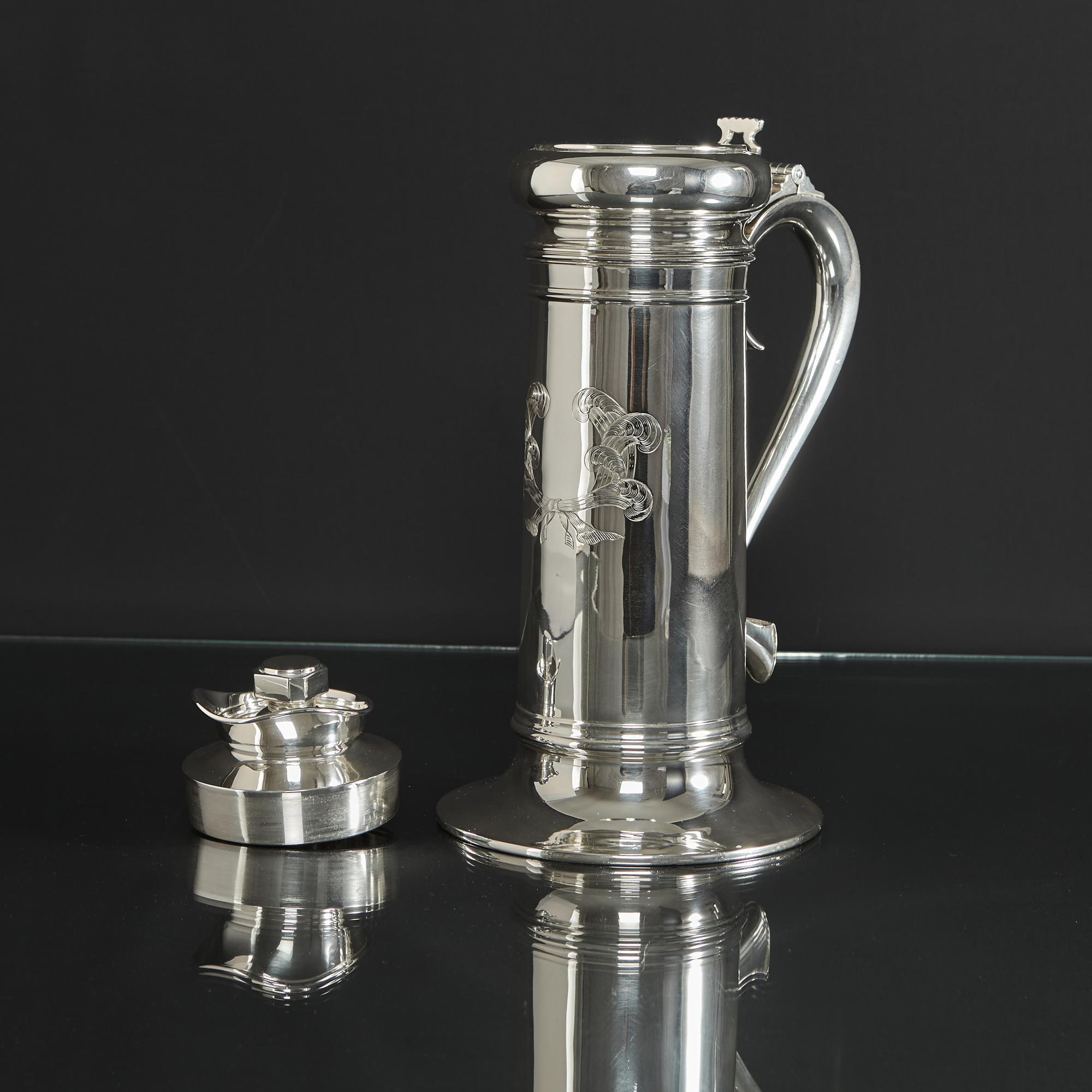 Antique novelty silver cocktail shaker in the form of an early 17th century tankard, fitted with a hinged cover and a cut-out thumbpiece. The interior is fitted with a twist and lift-off cover that features a clever opening and closing swivel