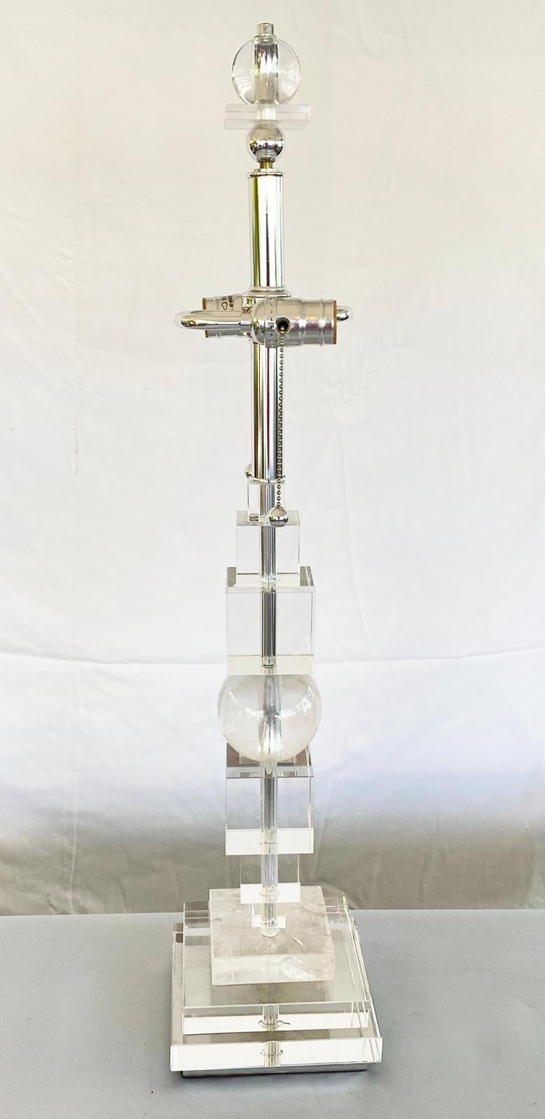 Unusual single lamp of stacked rock crystal and Lucite; Graduated sizes of acrylic cubes are stacked between a sphere and block of translucent pure quartz crystal, on a graduated base and surmounted by S-cluster socket fittings; a matching finial of