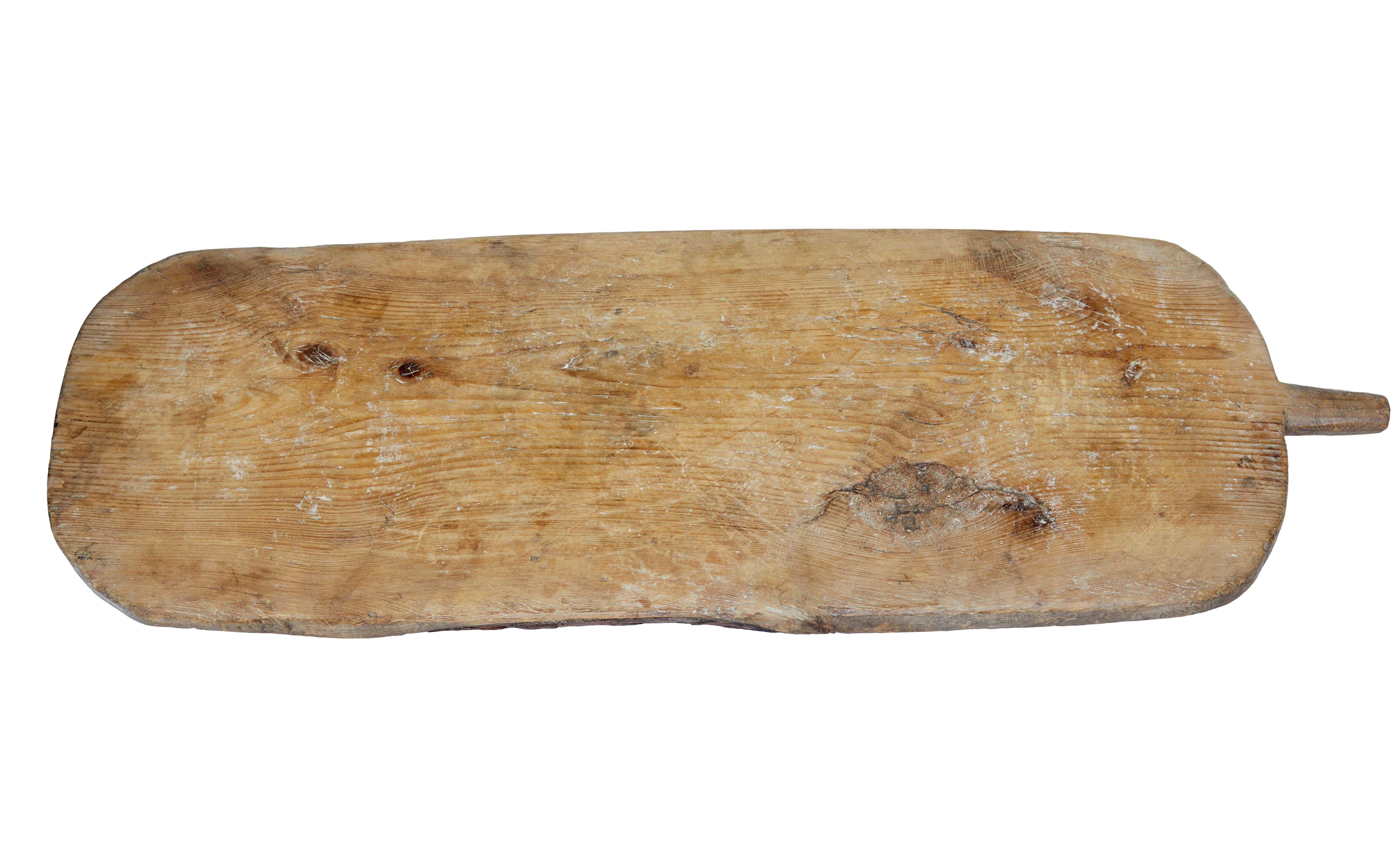 19th century rustic Swedish bread / chopping board, circa 1880.

Piece of traditional Swedish table wear, now ideal for a table serving center piece or platter.

Rectangular main shape with handle, carved legs in the solid on the