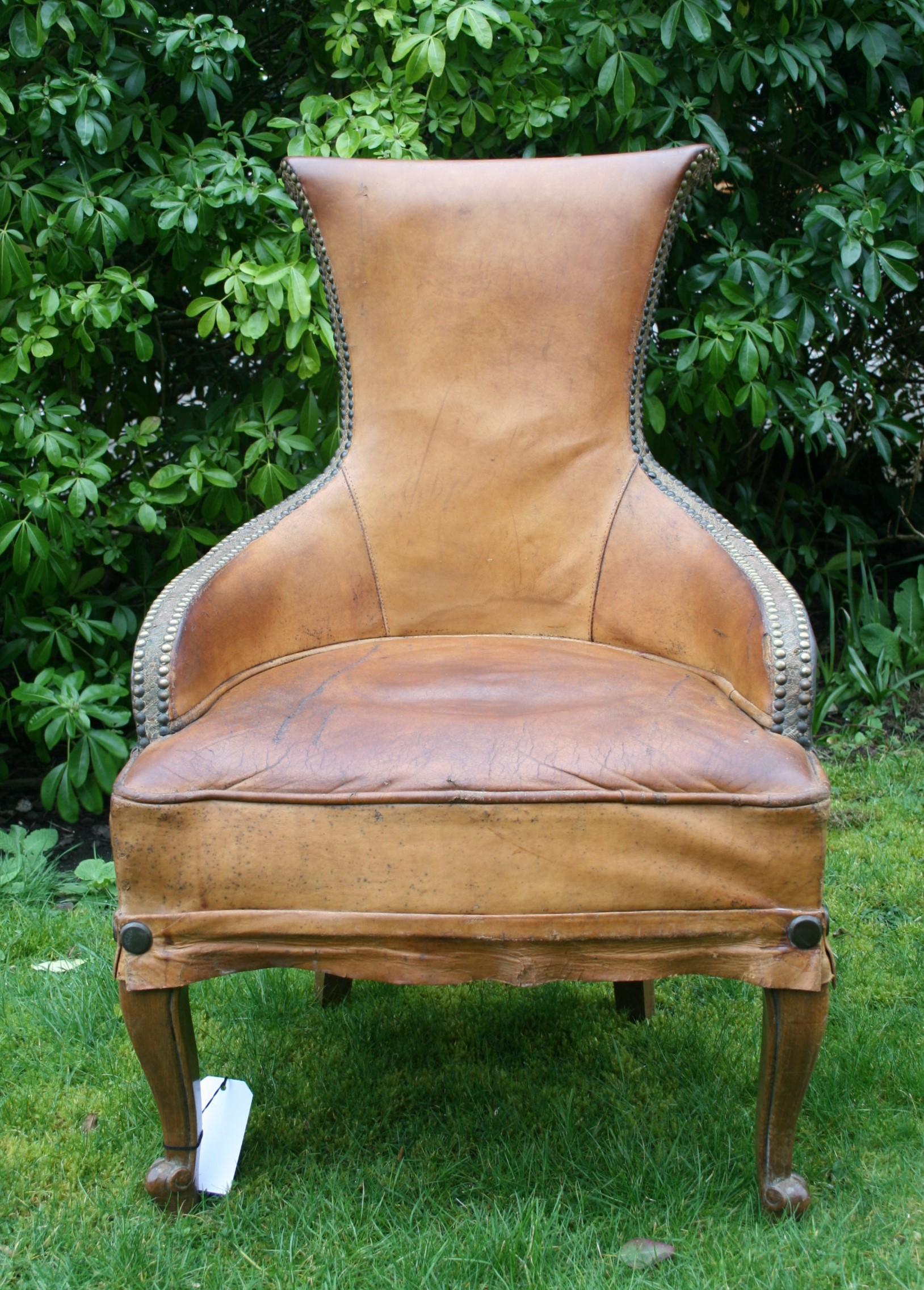 Small leather armchair in leather with cab legs, a very cool shape to this early 20th century chair, leather has old marks and stains but in general good condition.
   