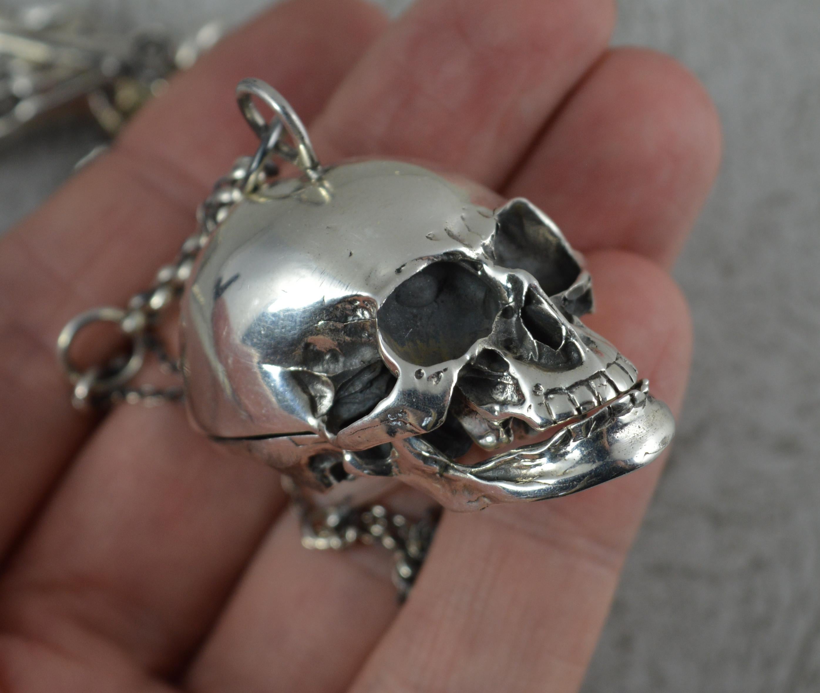A superb and highly unusual gothic skull pendant and chain piece.
Designed with a plain pocket watch tbar with hand below. The chain includes a bone and skull and bone link. The end is set with a watch key type piece.
Complete with a large and heavy