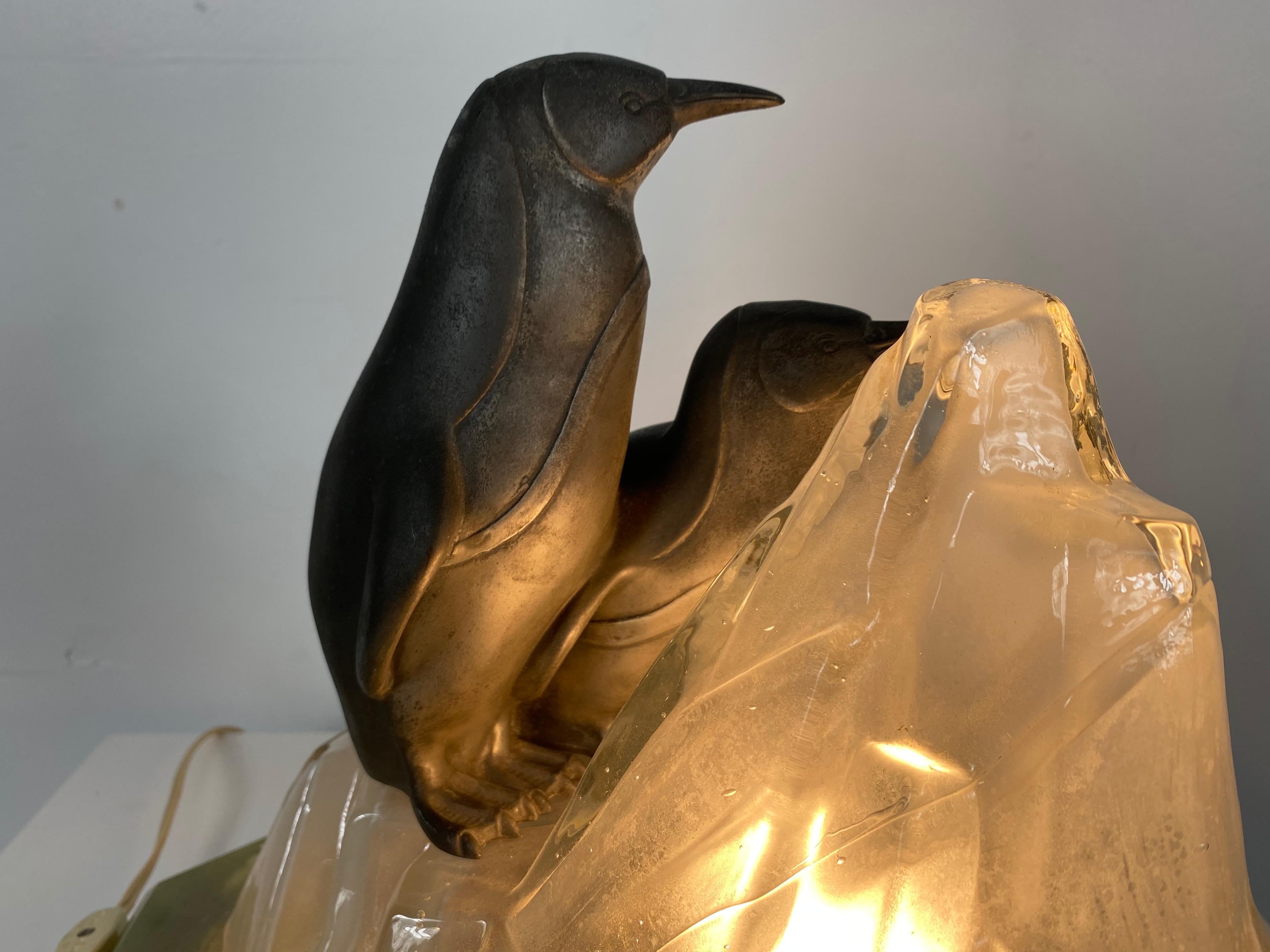 Unusual, stylized Art Deco penguin's and glass ice glacier table lamp, truly charming and very unusual, featuring two stylized penguins a-top a cubist shape ice glacier. Mounted to green marble base. Tested and all electrical working perfectly.
