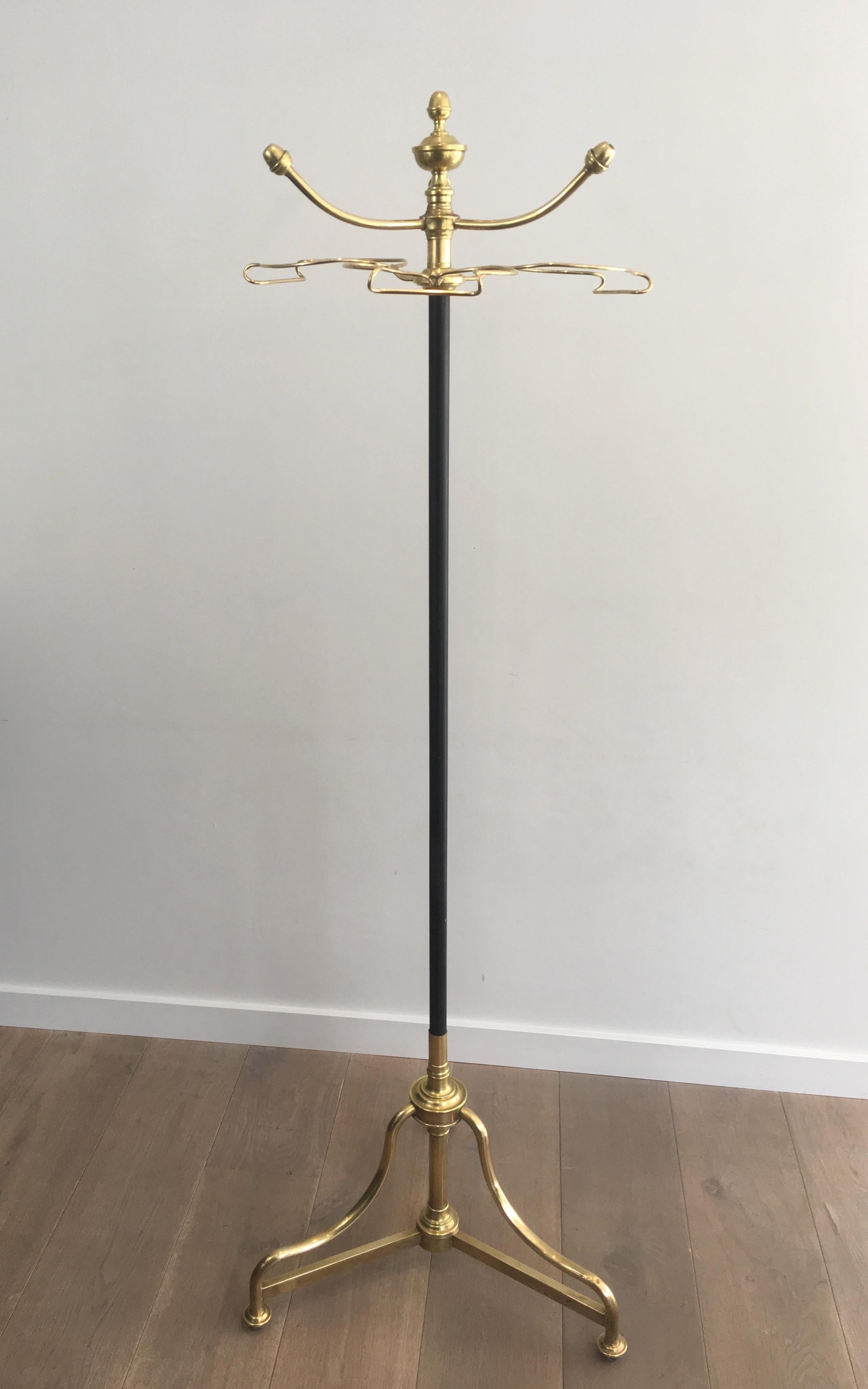 This very nice and decorative coat and hat rack on stand is made of brass with a black lacquered central part. This is a French work, circa 1900.