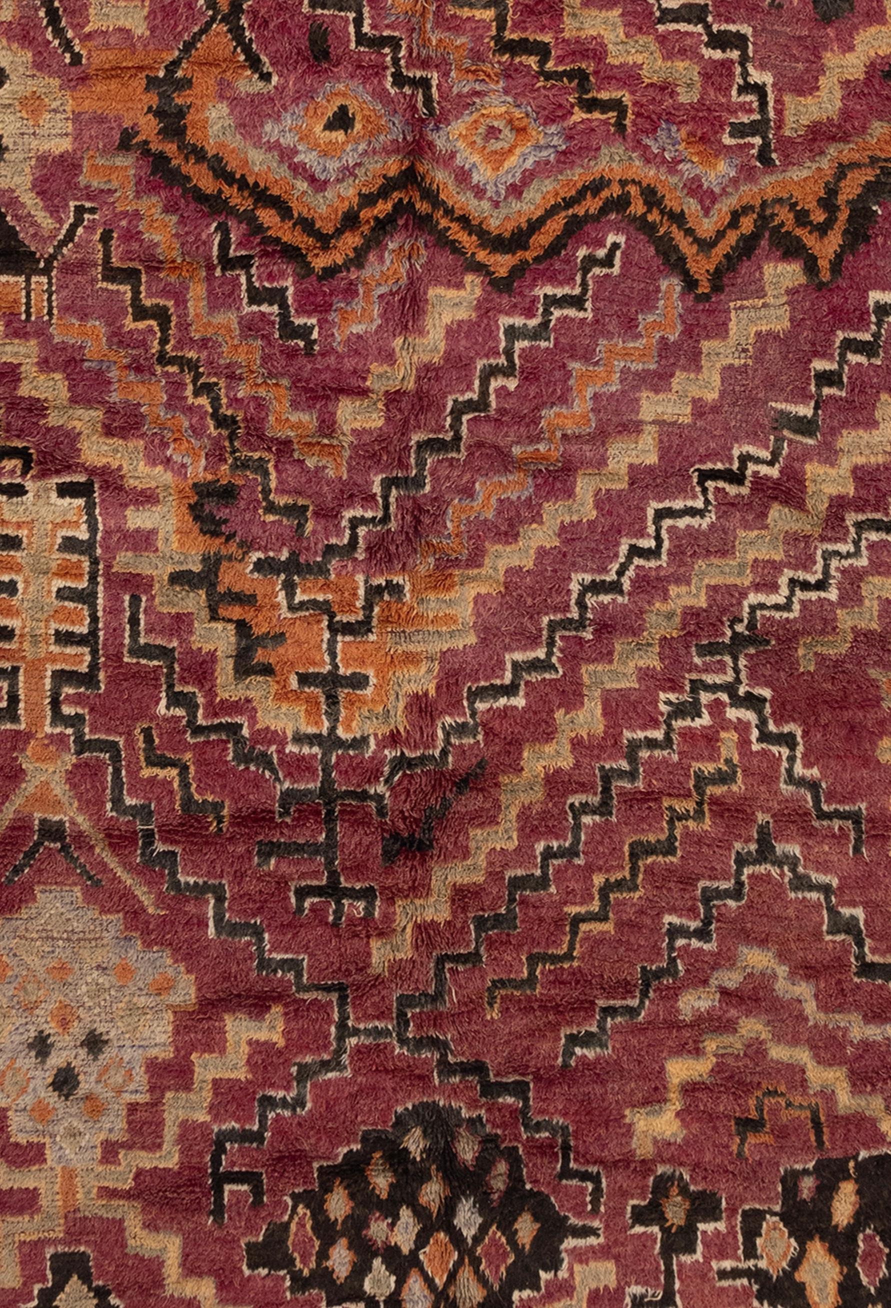 Beautiful tribal moroccan rug dating from the 1930's. Vibrant colors and distinct patterns throughout the piece, including lovely border designs.